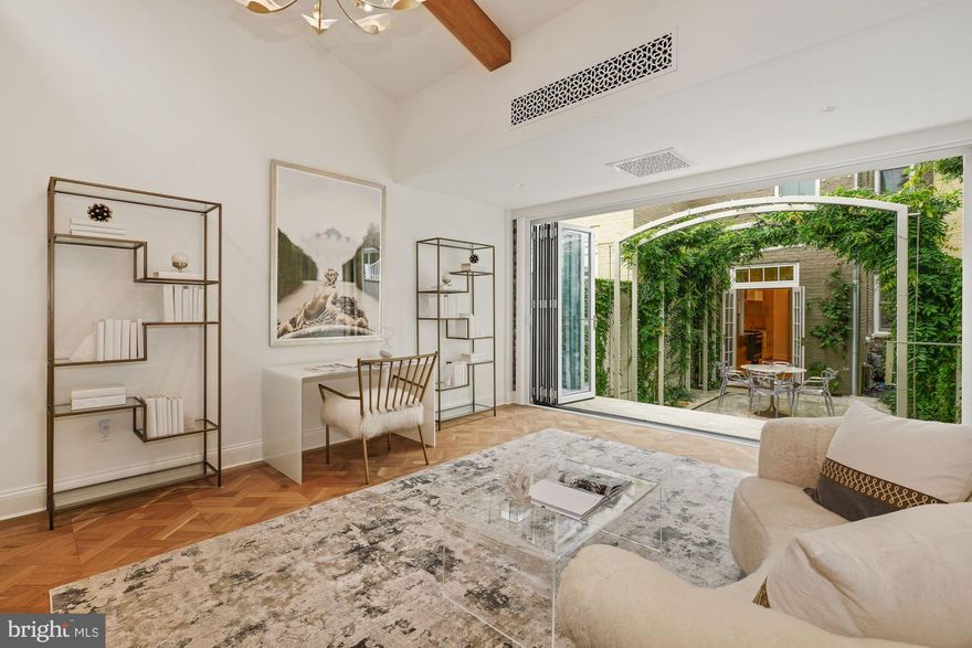 An EXTRA-extraordinary new price!  A total renovation by BOWA Builders of this West Village Georgetown Victorian was completed in 2020, undertaken with an artist's eye for the exquisite detail and rare finish. No expense spared, the result is a shimmering, light infused jewel of singular design and unparalleled craftsmanship. Throughout the home are custom parquet floors inlaid with brass, and walls with intricate plaster ornamentation by the Greg Giannetti Studio. The kitchen has cabinets of unusual hammered brass, and every bathroom showcases rich marble flooring and walls.  The main level has tall French doors to an enchanting rear courtyard with bubbling fountains and wisteria entwined along the arches of a romantic pergola; beyond is a separate Carriage House with a NanaWall that can be completely opened to the courtyard. The home has a beautiful bedroom and dressing room on the second floor plus an additional bedroom (or office) and full bath on the high-ceilinged lower level. Two spacious parking places are located directly behind the carriage house. 3-D tour provided for out of town buyers.