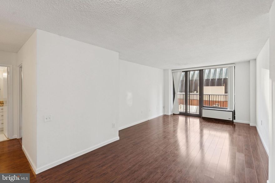 NEW INTERIOR PHOTOS COMING SOON! Fully renovated one bedroom boasting southern city views from a large  private balcony! Unit 7L at the Academy House features beautiful appointments throughout, including new hardwood floors, large bay windows and generously sized rooms. Enter into a foyer with extra storage space that leads to the sun-soaked living and dining room. The living room features a wall of sliding glass doors that lead to a tremendous French balcony overlooking the Kimmel Center. Adjacent, the fully renovated kitchen has white shaker cabinetry with brass drawer pulls, neutral granite countertops, white/brown subway tile backsplash, an oversized sink and stainless steel appliances. The spacious bedroom enjoys use of a wall closet, walk-in closet and nearby full hall bathroom. The bathroom is updated with white subway tile flooring, a shower/tub, an oversized single vanity with granite countertop, and a utility closet with a stackable washer/dryer.  Residents of Academy House enjoy a 24-hour doorman and a brand new, state-of-the-art fitness and aquatic center. There is valet parking in the building's garage for an additional monthly fee, subject to availability. The Academy House is located in the heart of Center City and within close walking distance to Rittenhouse Square, Washington Square, and the Broad Street and Market Street office corridors. The Philadelphia International Airport and Amtrak's 30th Street Station are easily accessible.