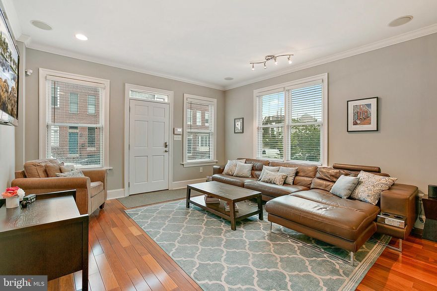 Incredible 4 story end unit in A+ C​​​​​anton location with parking and unbeatable city skyline & water views. Brand new construction in 2008 this home features endless high end​​​ finishes and spectacular trim throughout with elevator shaft ready for elevator install. Beautiful hardwood floors throughout main level including double sided stone fireplace, high end cabinetry, Wolfe range and Sub-Zero fridge, glass inserts with custom lighting in cabinets. Huge dining room that leads back to off street parking pad. Lower level is fully finished with movie theater or 5th bedroom and tons of storage. The second floor features a wet bar, big bedroom in the rear with private balcony, and huge suite in front with walk in closet and luxury bathroom. The 3rd floor has an additional, bigger wet bar with full wall of upper and low cabinets, another big bedroom in the rear and the primary suite in the front of the 3rd floor with walk in closet, enormous shower with 2 rainfall shower heads and tub inside shower. Every bedroom includes a bay window bump out with additional windows fully maximizing the end unit’s ability to showcase natural light. Access to rooftop deck is off the 3rd floor hallway. This home has been meticulously designed and maintained. Fresh paint and carpet. Additional storage with access from alley. Over 3600 sq ft of luxury living space!