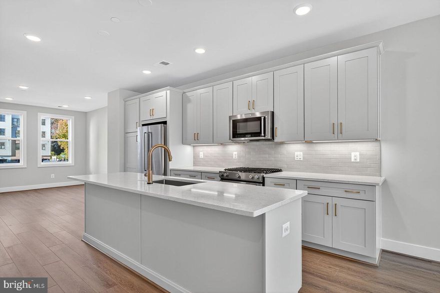 Beautifully designed townhome with a rooftop terrace. The main living level offers a bright and open layout, highlighted by a light-filled great room, generous dining area, and a center kitchen. The chef-inspired kitchen showcases Pearl Jasmine countertops, Artisan Maple Agreeable Gray cabinetry, gold hardware, and KitchenAid stainless steel appliances. Upstairs, the primary suite impresses with two walk-in closets and an upgraded primary bath. A spacious secondary bedroom with its own full bath completes this level. The third floor provides another bedroom, a versatile loft space, and access to the private rooftop terrace.