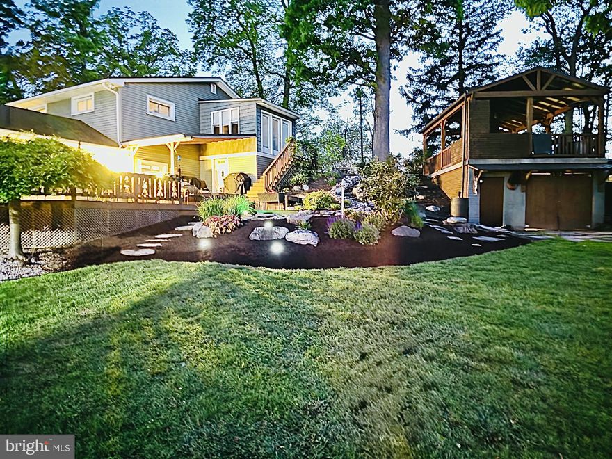 Hidden in plain sight with so much more than meets the eye, this stunning custom built ranch home is a perfect blend of traditional charm and contemporary elegance. With a major renovation completed in 2020, this residence boasts an impressive array of features that cater to modern living while providing a warm, inviting atmosphere. As you approach the property, you'll be captivated by the extensive hardscape that surrounds the home, creating a beautiful outdoor oasis. The meticulously designed stone retaining walls, complemented by a tranquil waterfall and Koi pond, offer a peaceful retreat right in your backyard. Imagine hosting gatherings on the expansive deck and attached covered brick terrace or enjoying quiet evenings on the wrap-around porch, all while soaking in the breathtaking panoramic views of the fields and mountains that stretch as far as the eye can see. Step inside to discover a thoughtfully designed interior that harmonizes comfort and functionality. The spacious layout includes four generous bedrooms and two full bathrooms, ensuring ample space for relaxation and privacy. The heart of the home features a cozy wood-burning fireplace, perfect for creating a warm ambiance during chilly evenings. The kitchen is a chef's dream, equipped with energy-efficient appliances, including a built-in microwave, double oven, and a built-in range, making meal preparation a delight. The home continues on to offer additional living space and convenient access to the attached and detached garages, providing plenty of room for vehicles and storage. With a total of four garage spaces parking will never be an issue for you or your guests. The exterior of the home is equally impressive, featuring a large like new bank barn, a metal storage building, a dedicated play area with equipment, and beautifully landscaped grounds that enhance the overall appeal. The property sits on nearly an acre of land, providing a sense of privacy and space that is hard to find. This home is not just a place to live; it's a lifestyle. With its perfect blend of indoor and outdoor living, modern amenities, and stunning views, it's an opportunity that won't last long. Experience the tranquility and beauty of this exceptional property-your dream home awaits!