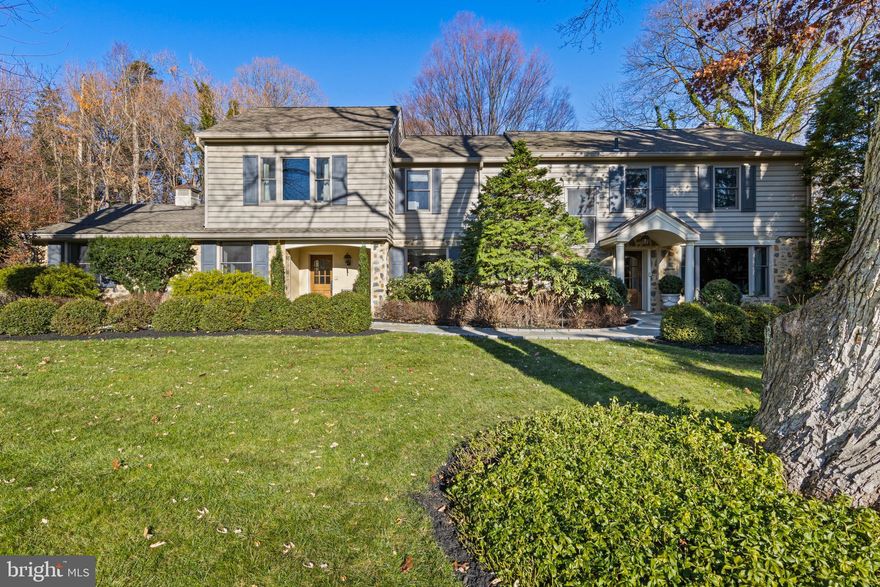 Welcome to 1633 Lark Lane, a meticulously maintained and thoughtfully upgraded 4-bedroom, 3.5-bath Colonial in the award-winning Lower Merion School District. Situated on a private lot that is well over an acre, at the end of a quiet cul-de-sac next to fifty acres of preserved land,  in a welcoming neighborhood, this home offers a peaceful, country-like atmosphere, all while being just minutes from the Villanova train station, Amtrak and the vibrant communities of the Main Line. Built in 1957, this spacious home seamlessly blends the character and craftsmanship of a classic home with the clean lines and contemporary updates. Every detail has been carefully maintained and enhanced using the highest quality materials, with expert guidance from professional landscapers, hardscapers  and designers.
A classic mix of stone and light gray siding, complemented by dark gray shutters and meticulously designed landscaping, elevates the home's curb appeal. A Belgium block driveway, lined with three stately stone columns topped with lanterns, makes for a grand entrance. Cobblestone pavers, a retaining wall, and a new portico with copper roof elevate the exterior. Dozens of acres of deed-restricted open space sit to the left, creating a peaceful oasis and ensuring privacy. Custom oversized front doors with Rocky Mountain hardware set the tone for both the formal entrance door and the mudroom door for everyday convenience.
Step into the inviting foyer, where a new banister and railings enhance the home’s timeless charm. The renovated kitchen combines modern elegance with functionality. White quartz countertops and a quartz slab backsplash complement the inset white cabinetry with glass door accents. A center island with prep sink and island seating is ideal for casual dining, while high-end appliances, including a Sub-Zero refrigerator, Theramador professional range, and Miele dishwasher, elevate the cooking experience. A built-in banquette with white leather upholstery and a modern chandelier create a welcoming dining space. Adjacent to the breakfast area, custom-built arched bookshelves frame the wood-paneled pantry doors. A desk area is also found here. The formal rooms on the main level offer elegance and versatility. The dining room features custom marble built-ins for showcasing fine dishware, and French doors allow natural light to flood the space. The family room and library provide panoramic views of the expansive backyard, blending indoor and outdoor living. New ceiling fixtures and sconces in the dining room add a refined touch. A powder room, also with new fixtures, and a mudroom with access to the attached two-car garage complete this level.
Upstairs, the primary suite offers a luxurious retreat, complete with a spacious walk-in closet and a stunning sitting room/office with a wall of windows and very high ceilings. The primary bath has been updated with new faucets and lighting fixtures for added elegance. Three generous additional bedrooms each include built-in closets. The brand-new lower level (2025) adds versatility, featuring a bonus room with LVP floors, a dedicated exercise room with tile flooring, and a full bath. Recent upgrades include a French drain, sump pump, new windows and a Generac whole-house generator for peace of mind. A true highlight of the home is the spacious, private backyard. The design of the home ensures a seamless connection to the outdoors, with large windows offering panoramic views from the kitchen, family room, library, and sitting room. Step outside onto the expanded patio, where a built-in Viking gas grill and lush landscaping create a private oasis. The flat driveway doubles as a pickleball court, and the spacious yard offers ample room for outdoor activities. Located in a welcoming, walkable neighborhood, this one-of-a-kind Colonial offers a rare opportunity to own a thoughtfully updated, move-in-ready home in a prime Main Line location.