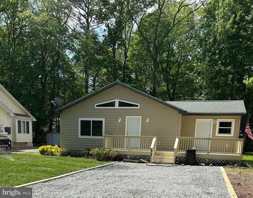 Adorable Rancher is larger than it looks.  Located on a treed street in Ocean Pines, MD, near parks and swimming pools.  This home is economical to heat and cool with a newer HVAC unit.
Outside you will pull into a large deep driveway able to park 4 vehicles or boat trailer. Beautiful front, newly sodded yard and mulched beds ready for your perfect idea of plantings or decor.  You will rise up to a large freshly painted front deck, ready for relaxing with morning beverage or evening drinks. 
The front of the home has NEW upgraded architectural shaker style siding, NEW big oversized window, NEW exterior doors and NEW exterior lighting.
As you enter, you will feel the surprising spaciousness of the open floor plan with cathedral ceiling over the living room, dining room and kitchen combo.  The kitchen island lends plenty of counter space for the full kitchen.  All appliances are included , plus a washer and dryer behind double doors in kitchen. There is a family room off the kitchen, which could double as a guest bedroom, den, playroom, office, pet plaza, or craft/hobby area.
The bright hallway features NEW interior doors leading into your 3 large-sized bedrooms and a bathroom with full size tub.  The master bedroom has a full bath with shower stall.
There is an enormous fenced-in back yard with a small concrete patio and fire pit.  The land is high and dry and perfect for entertaining, play ground equipment or run yard for your pets. Outside the fence is a tool shed.