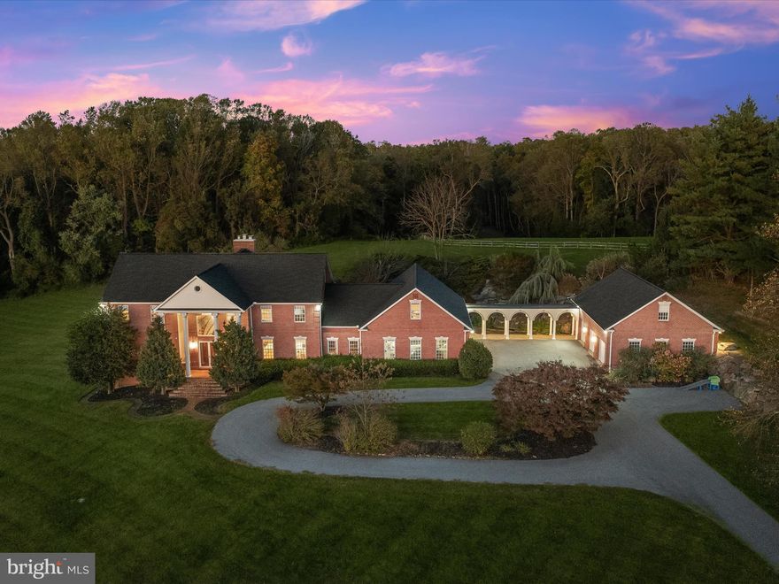 A masterpiece of design and craftsmanship, this extraordinary estate sits on 8.12 acres of rolling hills, lush pastures, and mature woods. Six bedrooms and five and a half bathrooms span four impeccably designed levels, offering an unparalleled living experience. A long private drive winds through manicured lawns, creating an unforgettable approach to this grand residence. Step inside the breathtaking two-story foyer, where marble floors, floor-to-ceiling windows, and dual staircases set an impressive tone. A sunken living room invites relaxation with its wood-burning fireplace, while the family room features sliding pocket doors leading to a sophisticated office with a spiral staircase to the lower level. The showstopping gourmet kitchen boasts granite countertops, a stylish tile backsplash, soft-close cabinetry with accent lighting, ample storage, high-end appliances, and a pot filler above the gas cooktop. A charming breakfast nook offers a cozy spot for casual dining, while the elegant dining room is ideal for hosting gatherings. Just beyond, a well-placed half bathroom, pantry, storage closets, and access to the attached garages add convenience. Entertainment and leisure abound in the finished lower level, featuring an expansive recreation room with a wet bar, a game room, a theater room, and generous storage. The fifth bedroom, along with an adjacent full bathroom and a walk-in shower, provides a private retreat for guests. Ascending upstairs to the lavish primary suite, a true sanctuary with a soaring cathedral ceiling, serene rear views, and a pellet stove for added warmth. The opulent ensuite bathroom offers a large jetted soaking tub, a dual-sink vanity, and an oversized waterfall walk-in shower with body sprayers. A massive walk-in closet, laundry, and a sitting room, perfect for a private office or lounge, complete this indulgent retreat. Down the hall, a second bedroom features a private ensuite bathroom with a walk-in shower, while two additional bedrooms share a well-appointed bath with a tub-shower. A versatile fourth level offers endless possibilities with a spacious bedroom, a full bathroom featuring a charming claw-foot tub, and additional flexible living space. Outdoor living is just as remarkable, with a serene rear patio that provides breathtaking views of the surrounding landscape. A three-car oversized attached garage ensures ample parking, while the detached garage offers even more space, complete with a finished upper level currently used as a home office. Every detail of this estate reflects thoughtful design and luxury, from exquisitely updated bathrooms to zoned heating and cooling systems for year-round comfort. Experience the pinnacle of elegance and tranquility in this extraordinary home.