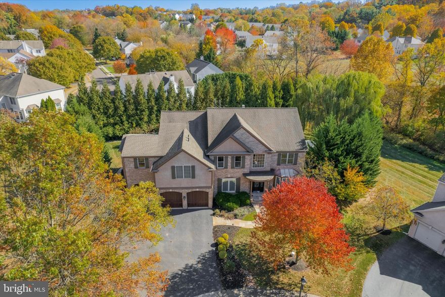 Timeless Elegance Meets Modern Luxury at 3 Applewood Drive

Nestled on a private cul-de-sac in the prestigious Reserve in Lafayette Hill, 3 Applewood Drive is a masterfully designed custom estate that redefines luxury living. Set on a beautifully landscaped half-acre lot, this home offers both privacy and grandeur. From the moment you step through the African mahogany front door, you’re welcomed by a breathtaking chevron marble foyer, illuminated by a grand Maxim Lighting Chantilly chandelier—setting the tone for the home’s exquisite craftsmanship. A striking architectural staircase with wrought iron spindles winds elegantly upward, while 8-foot doors, 9-foot ceilings and rift-and-quarter-sawn white oak floors extend throughout the main level.

At the heart of the home, a stunning 250-gallon saltwater reef aquarium serves as a captivating centerpiece seamlessly transitioning into the chef’s kitchen—a true culinary masterpiece. Handcrafted walnut cabinetry, a custom François & Co. marble backsplash, and a dramatic wall of custom cabinetry with wood-carved overlays over mirrored doors create a striking visual impact. Premium appliances, including a Wolf range, double wall ovens, convection steam oven, warming drawer, and Sub-Zero refrigerator and freezer, ensure effortless entertaining, complemented by two dishwashers and an expansive island.

Adjacent to the kitchen, the dining room is a study in refined elegance, featuring an antique mirror backsplash, and a mosaic sink, all anchored by a built-in Miele coffee system. Across from the dining area, a sophisticated living room offers an intimate retreat for quiet reflection or lively gatherings. The family room exudes warmth with its coffered ceiling, custom François & Co. fireplace, and built-in cabinetry, while the sun-drenched solarium with radiant travertine flooring seamlessly extends the living space into nature. Completing the main level, the powder room boasts  an Artistic Tile stone-and-brass accent wall, adding a touch of timeless luxury.

A Private Primary Suite Unlike Any Other
Upstairs, the primary suite is a retreat of unparalleled sophistication, transformed by a two-story addition. This serene haven includes a private den with a fireplace, TV, and under-counter refrigerator with refrigerator and freezer drawers—an elegant escape within your own home. The spa-inspired ensuite bath pampers with radiant heated floors (including the shower), a Kohler steam shower with light therapy, Walker Zanger tile, and marble countertops. A custom boudoir with a center island and a laundry room with dual washers elevate everyday luxury.

Beyond the primary suite, the upper level offers an inviting open loft area, perfect for a secondary lounge. The 2nd floor includes three additional bedrooms, each with its own private ensuite bath, ensuring ultimate comfort and privacy. One of these bedrooms boasts a full walk-in closet, adding an extra touch of indulgence.


Resort-Style Lower Level & Outdoor Sanctuary
The lower level impresses with a spacious family room, a private gym, and a fifth bedroom and full bath. A walkout leads directly to the resort-style backyard, where a heated saltwater pool, hot tub with a waterfall feature, and stone patio with a gas-assist fire pit create an idyllic outdoor retreat. The fully equipped outdoor kitchen—featuring a Lynx BBQ, warming drawer, built-in blender, and cocktail station—is framed by lush hydrangeas, roses, and raised garden beds, all overlooking the adjacent nature preserve.

This smart home includes:
 ✔ 2 - Whole-house humidifiers & air cleaners
 ✔ Lutron lighting system
 ✔ Sonos whole-home & outdoor sound
 ✔ Reverse osmosis water system.
A 2.5 car garage —a rare feature in the neighborhood—further sets this home apart.  With three fireplaces, intricate millwork, and designer finishes throughout, 3 Applewood Drive is an architectural masterpiece, offering you unmatched elegance, comfort, and modern luxury!