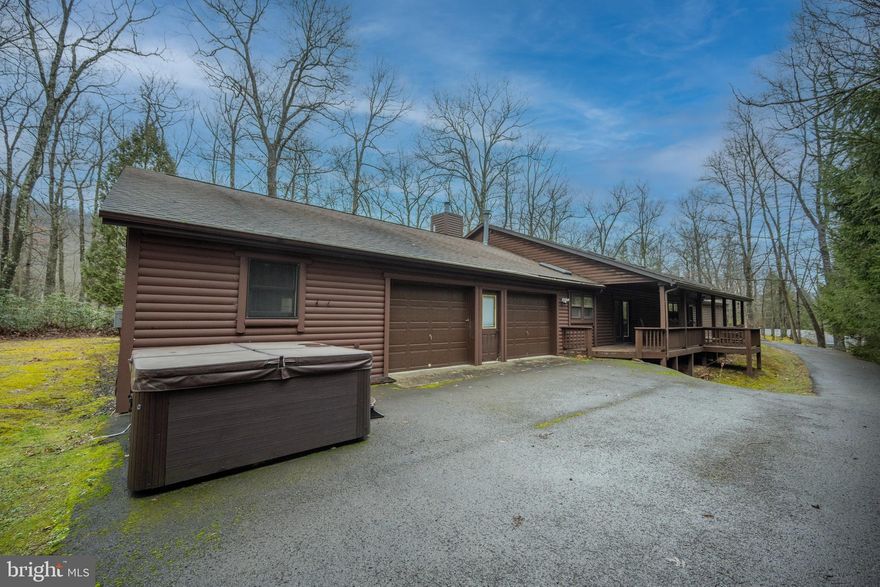 One-of-a-kind Deep Creek retreat with proven income potential! Set on 1.27 private wooded acres in the desirable Gleanings community, this distinctive log-sided lodge offers over 4,000 sq ft of flexible living space and has been an established, successful Airbnb with even stronger potential for full time investors. The main residence features three spacious ensuite bedrooms, a dramatic great room with vaulted ceilings, and a stunning stacked-stone wood-burning fireplace that creates true mountain-lodge ambiance. The open-concept kitchen with center island functions well today with excellent potential for future updates. A rare and valuable bonus is the attached, fully handicap-accessible guest house offering two bedrooms, one bath, a and living area—ideal for guests, multi-generational living, or maximizing rental income. Garages have been fully finished to help maximize additional living spaces perfect for providing that needed separation during large group stays. Surrounded by privacy and nature yet just minutes from Deep Creek Lake amenities and the Wisp Ski Resort,  this property is a standout opportunity as a primary residence, vacation escape, or high-performing investment.