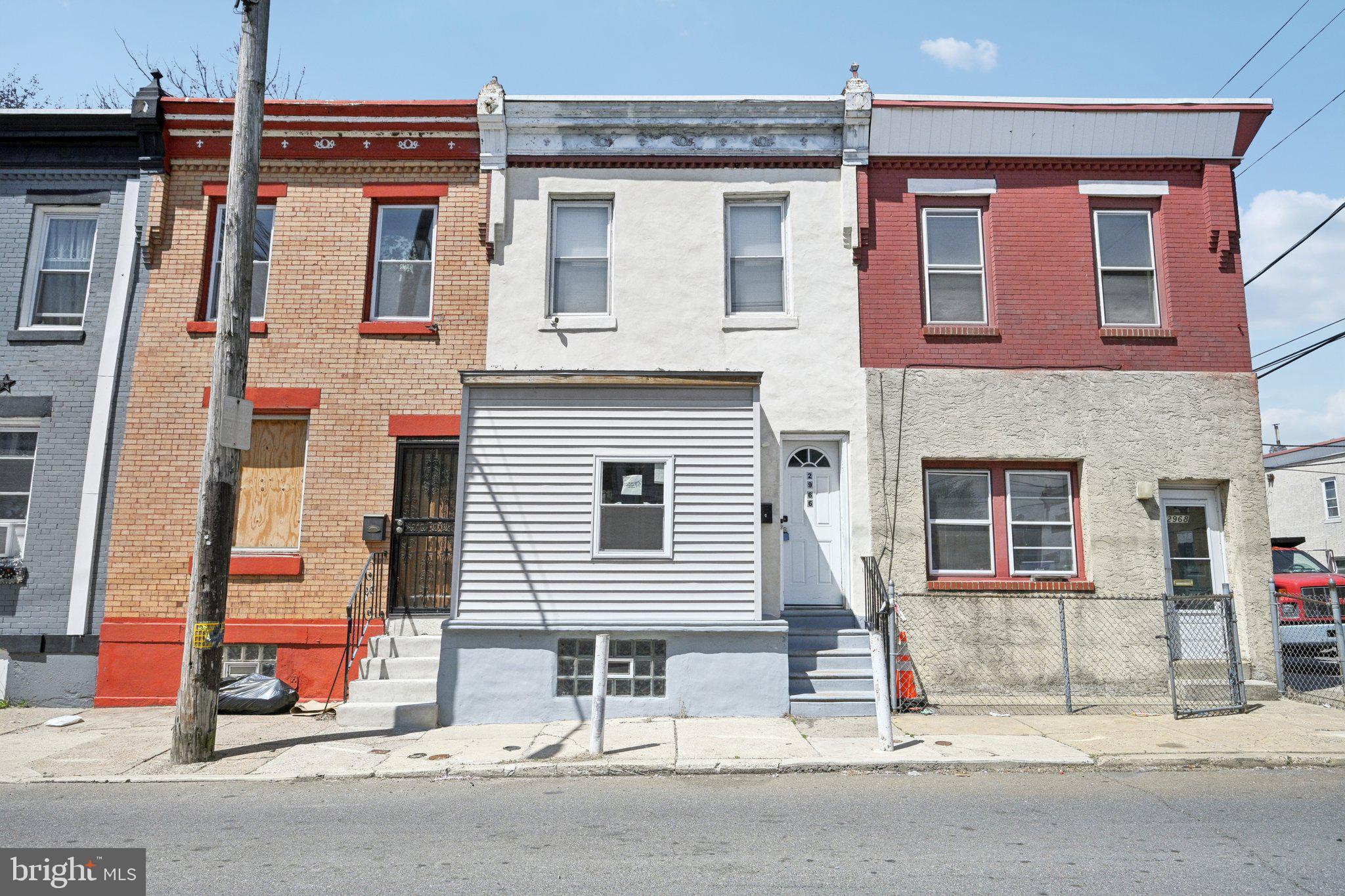 Welcome to this beautifully updated rowhome located in the heart of Allegheny West, where modern design meets timeless character. Once inside discover a bright and airy open-concept main floor, featuring hardwood floors and stunning exposed wooden beams that add warmth and architectural charm. The spacious living room flows seamlessly into the dining area and kitchen, complete with stainless steel appliances, sleek grey shaker cabinets, and a classic tile backsplash—perfect for everyday living and entertaining alike. At the rear of the home, a dedicated laundry room offers added convenience with a utility sink and built-in cabinetry for smart storage solutions. Upstairs, you'll find two generously sized bedrooms, including a primary suite positioned at the front of the home with double closets for ample wardrobe space. A well-appointed full hall bath is shared by both bedrooms, and a hall walk-in closet adds even more storage to the upper level. The finished basement provides versatile additional living space—ideal for a home office, media room, or workout area—along with an unfinished section for all your storage needs. This home effortlessly combines style, comfort, and function in one of Philadelphia’s most desirable neighborhoods. Don't miss the opportunity to make it yours!