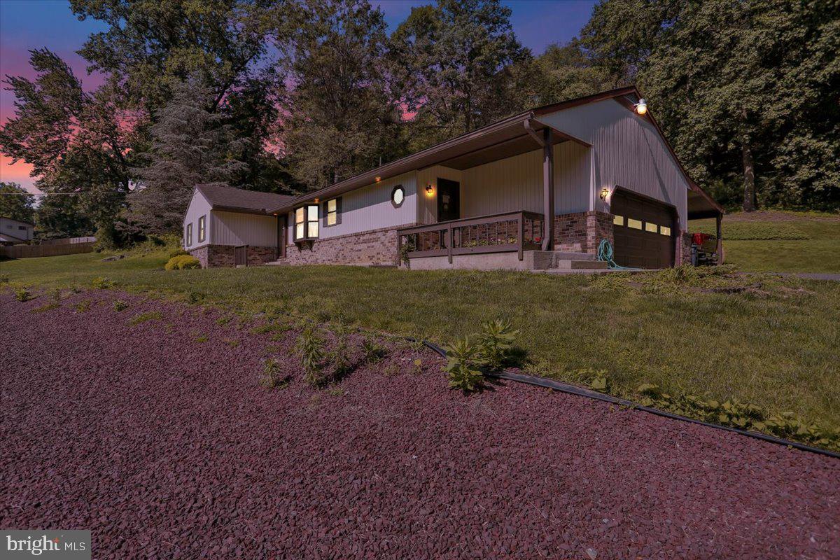 **A Naturalist’s Dream—Where Comfort Meets Wilderness**
If you’ve ever dreamed of a private retreat embraced by nature’s quiet majesty, this is where your journey begins. Nestled on 4.86 tranquil acres that border more than 600 acres of protected South Mountain YMCA Camp woodlands, this property offers the kind of peace and privacy rarely found in today’s world. Whether you’re a hunter, naturalist, or simply someone yearning for serenity, this sanctuary welcomes you home—with open skies, whispering trees, and abundant wildlife including deer, turkey, and more.
At the heart of this quiet escape stands a solidly built, lovingly maintained ranch home designed for easy, one-floor living. With three generously sized bedrooms and two full bathrooms, there’s space here not just to live—but to live well. The spacious primary suite is a true retreat, complete with two large closets and a private bath offering both comfort and convenience. The additional two bedrooms are light-filled, versatile spaces—ideal for guests, family, a home office, or creative studio.
The open-concept living areas feel warm and grounded, ideal for both quiet evenings and festive gatherings. Step outside to the full-length covered rear patio, where natural beauty meets timeless design. Overlooking custom stacked stone landscaping, this is a space made for entertaining, relaxing, and watching the seasons unfold in your own backyard.
The lower level is a blank canvas, offering even more room to grow—featuring a wood-burning fireplace, roughed-in plumbing for a third bathroom and a wet bar or sink, and endless potential for a recreation room, guest suite, or personal retreat.
Worried about power outages? You won’t be here. A whole-house generator ensures your comfort and security no matter the weather. For heating, you’ll find thoughtful flexibility: four-zone oil-fired hot water baseboard heating—including the garage—as well as an electric heat pump with backup. Two outdoor sheds provide ample storage for tools, gear, and seasonal essentials.
This is more than just a house. It’s a place to breathe, to explore, and to reconnect—with nature, with loved ones, and with yourself.