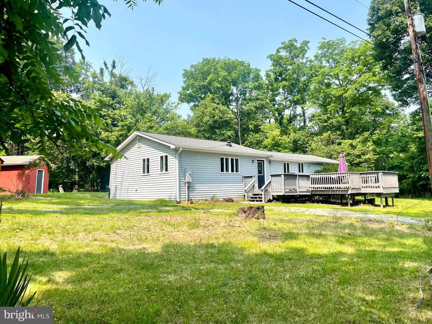 THIS PROPERTY MAY BE ELIGIBLE FOR A $10,000 GRANT! Come take a look at this updated and well maintained home in the community of Blue Ridge Acres in Harpers Ferry! As you pull into the warp-around driveway of the property you will be greeted by the large front porch that is perfect for early morning coffee or evenings with friends and family hanging out. Inside, you walk into a spacious open floor plan with the living room, kitchen, and dining room. Down the hall you will find the large primary bedroom and bathroom to the right. There are 3 other spacious bedrooms as you continue down the hall, the laundry room, and another bathroom as well. The first bedroom to the left down the hall could also be used as an office space or peaceful sunroom with all of the natural lighting coming in through the many windows! Sitting on a total of 4 lots, out back you will find 2 storage sheds that are being sold with the property for all of your extra things. There is plenty of space for the kids and/or pets to run around here. The Blue Ridge Acres Community Club is optional to join, and that includes the community pool and river access if you are interested in that! The location of this home is just minutes away from shopping, dining, commuter routes, and more! Schedule a showing and come check this home out!