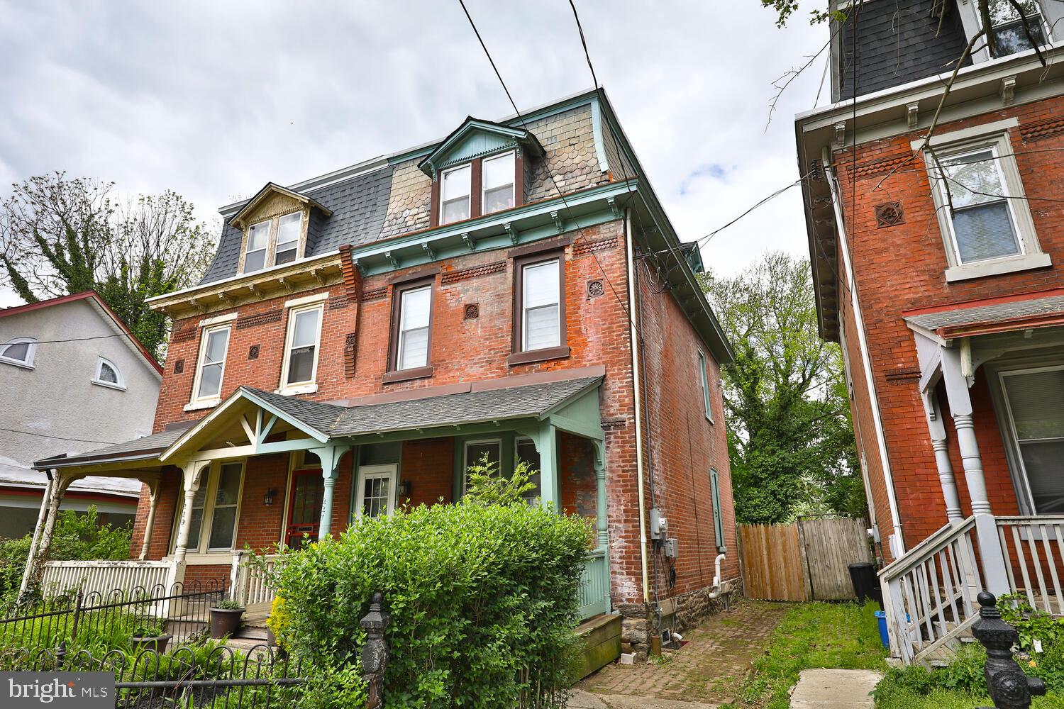 Original charm meets modern living in this meticulously cared for and updated 4 bed, 2.5 bath character-filled Germantown twin. As you approach, take note of the amazing brickwork, original detailing and inviting front porch and garden. Enter through the proper vestibule and notice the original hardwood floors, original baseboards, trim, woodwork and deep window sills throughout the home. The living room features a beautiful decorative fireplace, high ceilings, large window, and pocket doors into the dining room. There is plenty of space in the dining room for hosting all of your dinner parties! The eat-in kitchen has been renovated featuring newer appliances, granite countertops, plenty of counter and cabinet space, and a drinking water filtration system. Off of the kitchen you will find the mud room with new LG washer and dryer and first floor powder room. Through the mud room you will discover the enormous back garden and lawn, ready to be turned into your own personal outdoor oasis. Lush plantings surround the entire space, affording privacy and flexibility for whatever designs you have for the exterior. The original hardwood flooring continues upstairs, where you will encounter a bedroom or if you choose, a home office, at the top of the stairs with a gorgeous view out back. A full bath and spacious double hallway closet line the hallway on your way to the master suite. The master suite includes a bedroom large enough for a king bed, a massive walk-in closet, and full master bath with double vanity. The third floor features two additional spacious bedrooms with plenty of closet space, views to the front and back of the house, and deep window sills at the top of the stairs and in the bedroom, that can be converted to cozy reading nooks. Additional improvements include: blinds and window treatments throughout, a water softener for the entire house, new water heater, new storm door, a Simplisafe security system, and more. Much care was taken to preserve the integrity of the original architectural features, while modernizing plumbing, HVAC, gas and electrical systems. Conveniently located to area shopping, SEPTA regional rail, Route 1 and I-76, East Falls, Mount Airy, Chestnut Hill, and everything Philadelphia has to offer.