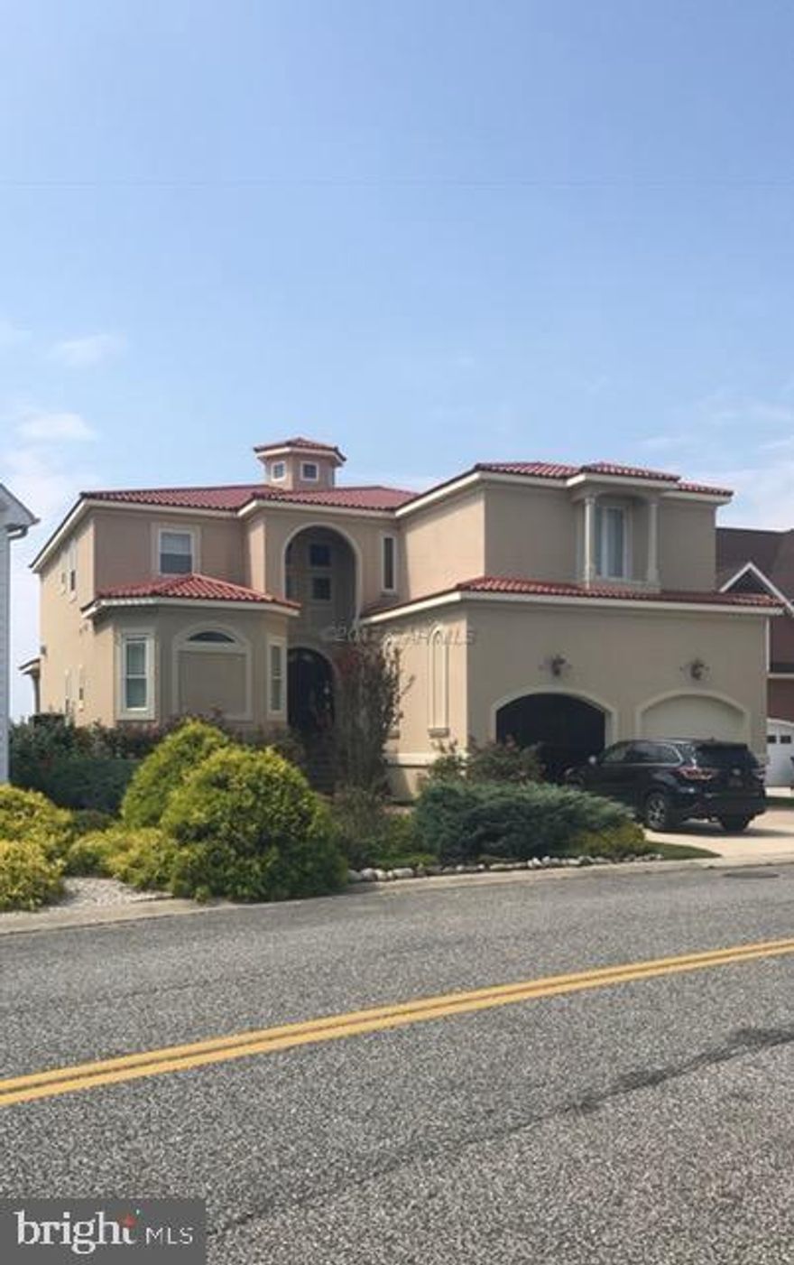 Stunning broad waterviews are yours in this impressive Bayfront home.  The moment you enter the door, you'll be wowed by the views and greeted by a welcoming foyer drawing you into the open concept gathering spaces and kitchen.  Some of the many fine features include ... imported tile flooring on the first level...Gourmet kitchen with gleaming granite, chef's Dacor gas range, stainless appliances, an island and breakfast bar...First floor master bedroom that opens to the bayfront covered patio and a spa-like ensuite bath. This home also features an elevator for your convenience.  The second floor is just as impressive ...upstairs you'll find a large game room/family room that opens to a balcony overlooking the water, 4 bedrooms each with it's own bath.  You need to see to appreciate.