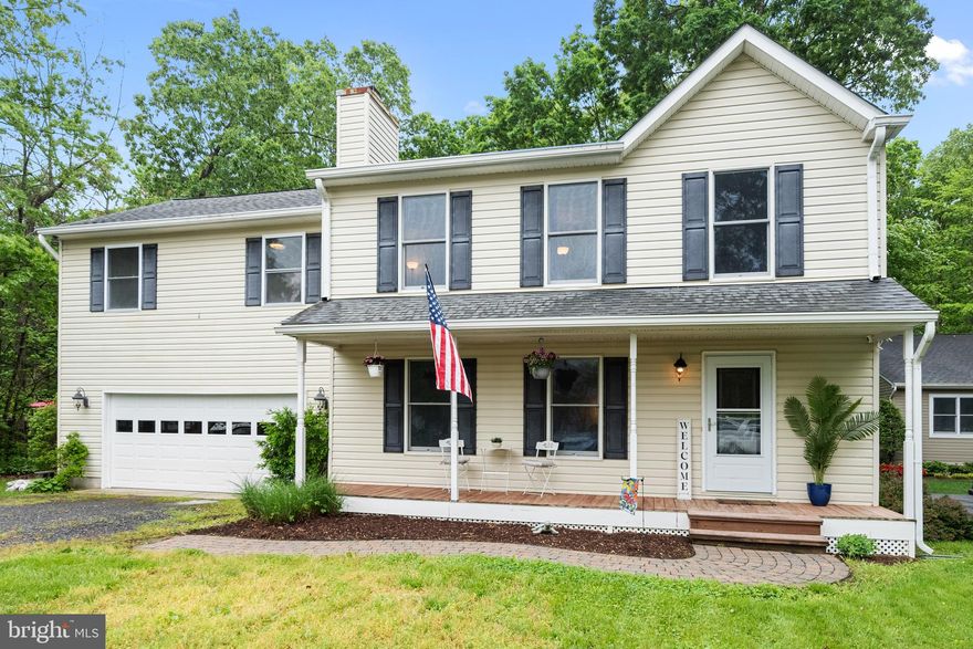 Welcome to your perfect home! This charming colonial residence, featuring an inviting front porch, offers 5 spacious bedrooms and 2.5 bathrooms. As you step inside, you’ll be greeted by a cozy living room complete with a wood-burning fireplace, ideal for family gatherings and entertaining guests. The ample two-car garage provides easy access to both the home and the expansive backyard.

Step outside to discover a nearly half-acre, fully fenced backyard that adjoins peaceful woods, creating a tranquil and private oasis. This outdoor space is perfect for summer barbecues or serene evenings spent on your deck or large paver patio, soaking in the beauty of the night sky.

For your peace of mind, this residence features a new roof and a newly encapsulated crawl space complete with a dehumidifier, ensuring a worry-free living experience.  The HVAC was replaced in 2019.

Situated in a sought-after water-privileged community, you’ll have easy access to local amenities that enrich your lifestyle. With a prime location just 45 minutes from Washington D.C., Andrews Air Force Base, and Baltimore, you can enjoy the perks of city living while retreating to the calm of your new abode.

This home is ready for you to move in and start building memories. Don’t miss the opportunity to make this stunning house your forever home!

**Bonus:** The seller is offering an opportunity to assume the current VA loan, adding even more appeal to this exceptional property.