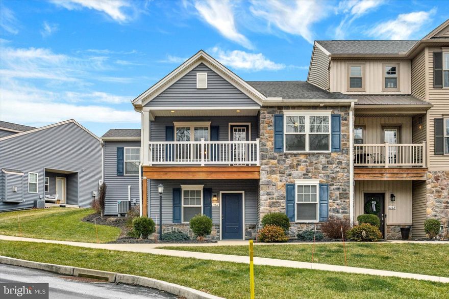 Welcome to this lovely townhome situated in the desirable Union Station community! Featuring the popular “Yawl” floorplan by Yingst Homes, this home boasts quality craftsmanship and comfortable, maintenance-free living. Step inside to an inviting open floor plan highlighted by the kitchen with granite countertops, ample white cabinetry, pantry and breakfast bar, perfect for everyday living and entertaining. Spacious family room with luxury vinyl plank flooring, window treatments and outdoor balcony access opens to a dining space with ceiling fan and an additional sunroom area. Primary suite boasts luxury vinyl plank flooring, walk-in closet and an attached full bath that has a walk in shower with seat. Additional bedroom and full bath offer convenient one level living. Enjoy relaxing mornings on the front porch or unwind on the upper balcony overlooking the surroundings. The full walkout basement offers endless potential for additional living space, storage, or future finishing. One car garage. Conveniently located to shopping, dining, and major routes, this townhome combines comfort, quality, and location—an opportunity you won’t want to miss! A joy to own!