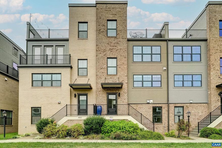 The views!!  Amazing!  Discover an extraordinary living experience in Old Trail, where this stunning four-story, townhome on green space combines modern design with breathtaking mountain vistas walkable to the Town Center. Step inside to an inviting, light-filled interior featuring natural hardwood floors, and custom window treatments.  The heart of the home is an open-concept living area with a gourmet kitchen that boasts espresso stained cabinetry, luxurious granite countertops and upgraded stainless steel appliances that opens to a great room with electric fireplace and large dining area. The bedroom level showcases a generously sized owner's suite with walk-in closet and a spa-inspired bathroom, featuring a sleek frameless glass shower. A second large bedroom with ensuite bathroom is great for guests!  The ground floor offers versatility with a third bedroom/home gym with full bathroom. Perhaps the true gem of this property is the spectacular loft leading to the rooftop terrace?an urban oasis with panoramic mountain views that will become your favorite retreat. New HVAC system in 2025 comes with warranty! Practicality meets luxury with a two-car garage and a convenient rear deck for outdoor dining and grilling Don't miss out!,Granite Counter,Wood Cabinets,Fireplace in Great Room