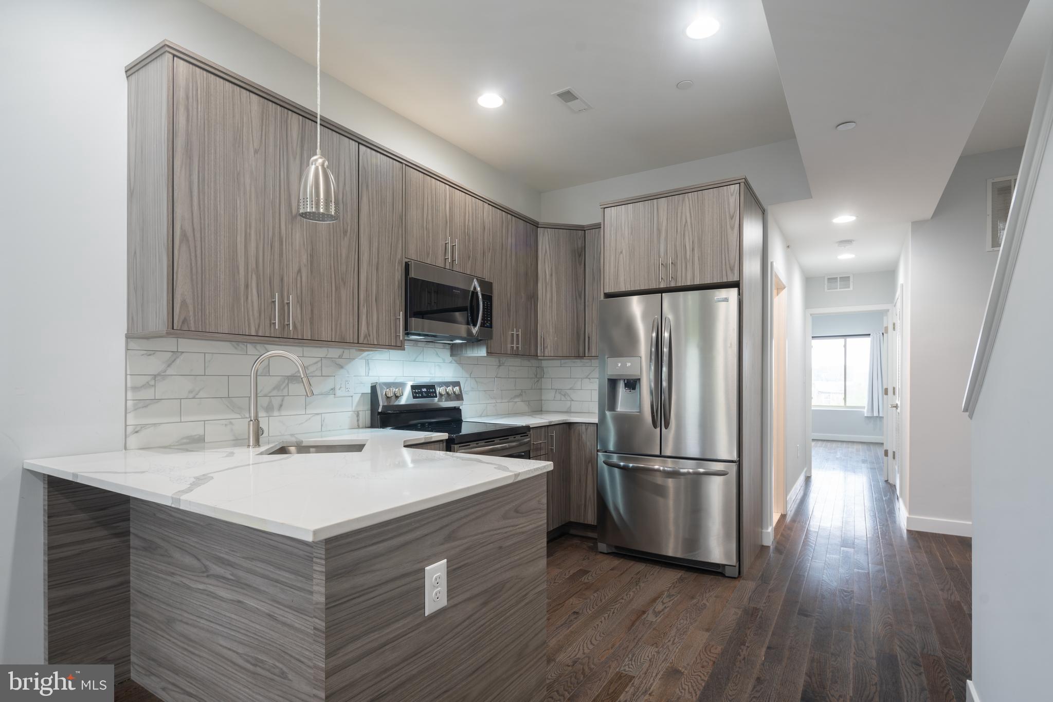 Thoughtfully laid out, new constriction 2 bed 1 bath apartment now available! This contemporary unit features modern appliances, large windows allowing for each room to be flooded with natural light, recessed lighting, and gorgeous hardwood floors. The kitchen comes equipped with a built-in microwave, stainless steel appliances, white shaker cabinets, granite countertops, a dishwasher, and tile backsplash! Both bedrooms are spacious with plenty of closet space. Enjoy your own private roof deck with wonderful views of the city! A great place to relax outdoor or entertain family & friends. The unit also conveniently has an in-unit washer and dryer as well as an integrated smart home technology such as built-in speakers throughout, an alarm, and a security surveillance system. You are within walking distance to plenty of cafes, restaurants, and bars such as Sutton's, Luna Cafe, Fresh Wellness Bar, Old Kensington Beer Garden, and Orignal 13 Ciderworks.