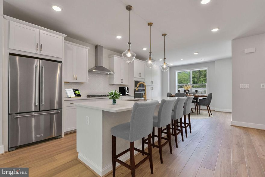 The bright and airy main level offers a spacious dining room, center kitchen, and light-filled great room with an electric fireplace and sliding glass doors that open to the deck. The kitchen is complete with white cabinets, Calacatta Gold quartz countertops, huge island, and stainless steel appliances. Upstairs you’ll find a large primary suite with two walk-in closets and an upgraded primary bath with quartz countertops. The second floor also has a conveniently located laundry room and a secondary bedroom that could be a second primary suite with a walk-in closet and private full bath. An additional bedroom and full bath complete the first floor.