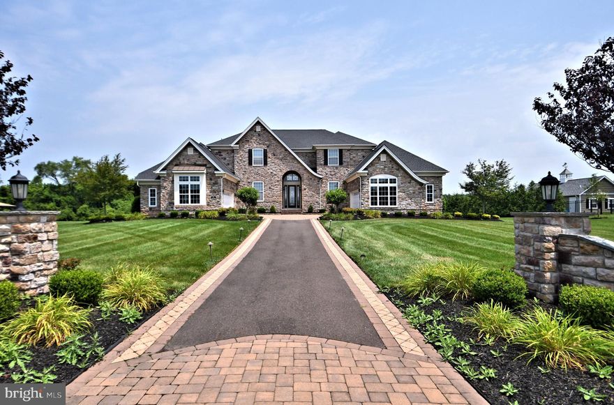 Location, location, location!  This luxurious Estate home, majestically situated on a premium lot of 1.01 acres in the desirable community of Reserve at Northampton, provides privacy and long, beautiful and open views! The custom paver driveway welcomes you to this opulent home that has it all!  Attention to detail, finest finishes, and outstanding craftsmanship are evident through every room in the home. Shadowbox moldings on all walls in first floor, foyer, second floor hallway and Master Bedroom. The magnificent marble foyer has an accent medallion design, a stunning butterfly staircase, and custom molding that immediately embraces you as you enter. The upgraded chandelier is on a winch to lower it to clean. Warm hardwood floors create a mellifluous flow throughout the home, evoking a relaxing feel. Entertaining is a true pleasure with the open floor plan. Expansive Conservatory has two sets of French doors and is another area to just relax. Designer Chef’s Palladium Kitchen, with upgraded cabinetry and granite countertops is the heart of the home and sure to please the chef with Sub Zero refrigerator, Jenn Air Double Oven, Stove with range hood, Pantry, and Breakfast area. Decorative kitchen ceiling medallion is a focal point. Large Breakfast area has 9’ patio door to outside.  Adjacent to the Kitchen is the Family Room with coffered ceiling, gas fireplace, custom window treatments and a custom door leading out to your outdoor area.  The backyard oasis has a paver patio, retaining walls, a large wood burning fireplace to gather around. The outdoor Granite countertop has a built-in gas grill for all your outdoor entertainment needs. Large yard with long, beautiful vistas on this desirable and private lot. Sophisticated moldings, mirrors and large windows adorn the elegant two-story Dining Room, setting the stage for memorable meals. Formal Living Room is sun soaked and overlooks the rear yard.  First floor office, with custom built in bookcases and French doors, is a dedicated work from home space. There is a spacious first floor Suite with a private bathroom, perfect for out of town guests, live in nanny, etc..  Designer Powder Room with decorator accents.  Pristine hardwood floors on the first floor, second floor hallway and Master Suite.  First floor laundry room has a utility sink and access to 2 of the 4 garages. Upstairs, the delicately curved overlook is flanked by columns and provides views below to the Dining Room and outside.  The luxurious Master Suite is a retreat unto itself with gas fireplace, glass French doors, detailed wood trim on ceiling and walls. From the sitting room, with a granite countertop and refrigerator, enjoy that morning coffee to greet the day or evening glass of wine to toast the night. The Owner’s Suite is an inviting and restful space. Master Bathroom is spa-like providing serenity with deep tub, marble floor and shower with large marble slabs.  Two walk in closets are custom designed with organizers. Decorative ceiling moldings add a touch of elegance to the Owner’s Suite.  Surround sound wired in the whole house and outdoor patio. 3 additional Bedrooms and 2 full baths. Upgraded light fixtures in the entire home. Home is beautifully landscaped with exterior lights.  Ten foot ceilings on first floor. 4 Car garage for the car enthusiast. Upgraded HVAC systems.  Sprinkler system in front and back of home and flower beds. Wired security system on all windows/doors on the first floor, garage doors and basement doors. 3 outside cameras, including front doorbell intercom with camera. Hunter Douglass sheer blinds in 1st and 2nd floors (except DR and LR). Custom paint in all rooms on the first floor and in the Master Suite.  Unfinished Walk Out basement has plumbing rough in for future bathroom is a blank canvas awaiting your touches. All of this plus the highly acclaimed Council Rock School District!  This exceptional home embodies upscale elegance and is for the truly discerning buyer.