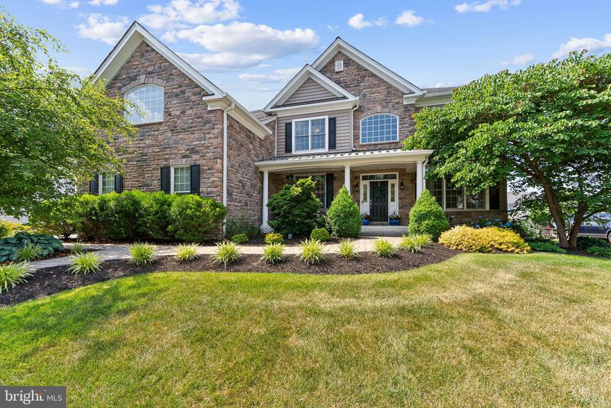 Welcome Home!  From the moment you arrive at 3979 Powell Rd.,  expect to be impressed.  This magnificent property is located in the highly sought after neighborhood of Byers Station.    As you stroll along the meandering front walk, you'll notice both the exquisite landscaping in addition to the gorgeous hardscaping.   The spacious front porch offers a respite from the heat, while the grand entry foyer beckons you in.  The soaring two story center hall features handsome hardwood flooring and a stunning staircase.  To the left you will find the formal dining room, enhanced with a gorgeous chandelier, decorative mill work and tray ceiling.  To the right is the formal living area with wall to wall built-ins, that is presently being used as a home office space.  As you step into the expanded, Palladian kitchen, you will notice you start to relax and unwind.  This kitchen will take your breath away, with a large center granite island, gleaming white cabinets and stainless steel appliances.  There is seating for 4 at the counter, but ample room for a large table in the breakfast area.    The family room is next, boasting a two story ceiling,  anchored by a wall of windows and an attractive stone fireplace and decorative trim work.   The open floor plan is desirable for family gatherings or entering a group!  The oversized deck is accessed from the kitchen and is just ideal for curling up with a book or dining al fresco.   Another level down is a hardscaped patio complete with fire pit - don't forget to pack the marshmallows.    The flat back yard is fenced in and ready to play!  A spacious laundry, a home office (or playroom!) and sizable pantry round out the first level.   Upstairs, the owner's suite awaits!   If you are looking for a wow factor, this room has it!  Accessed through double doors, the suite is enhanced with a vaulted ceiling and separate seating area done in hard wood.  Down the hall is a dressing area, three massive closets and the en-suite bathroom, with his and her vanities and a zen-like spa feel to it .     You will be amazed by the  upper level hallway that is open and airy, and leads to 3 additional bedrooms, (one en-suite bathroom) and a hall bath.    Upgrades to this property include: an expanded family room,  basement ceilings raised to 9 feet with walk-out access,  and 3 car garage which enhanced the size of the owner's suite significantly.   Neighborhood amenities include 2 clubhouses, 2 community pools, nature trails, tennis courts, playgrounds and more.  Conveniently located to major highways (PA Turnpike) shopping and restaurants, this one is the ideal Chester Springs!  Schedule your private showing today!