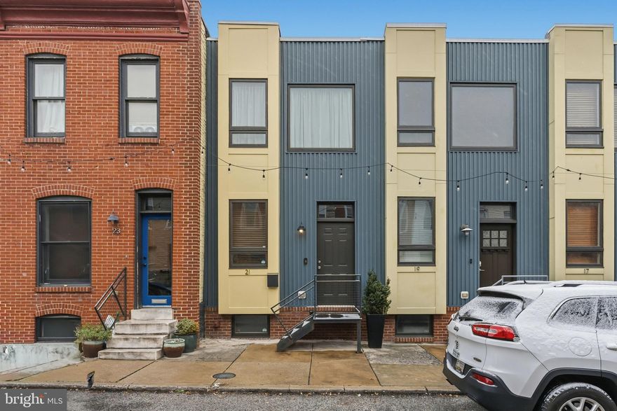 What a find at $308,000! Own one of the limited edition urban residences known as DeckerWalk homes just 1.5 blocks north of Patterson Park. Fully renovated in 2007 as an eco-friendly Envirowhome and enhanced with a new roof (2019), this modern residence offers the perfect blend of thoughtful design, sustainability, and urban convenience: enjoy  HVAC, a tankless water heater, sump pump, and other environmentally conscious systems that keep comfort high and bills low. Outside, a remote-access gated alley leads to your private parking pad with permeable pavers, providing rare convenience, added security, and a genuine neighborhood feel.
Step inside to hardwood floors that lead you through a bright, open main level. The spacious living room flows into a dining area, while the  kitchen stretches across the rear of the home—complete with a full wall of cherry cabinetry, granite countertops, generous prep space, and stainless steel appliances.
Upstairs, you’ll find two large bedrooms connected by an oversized, skylit bathroom featuring double vanities and a glass-enclosed shower. The rear bedroom offers built-in storage and opens to a low-maintenance composite balcony with decorative cafe lighting .The fully finished lower level,with polished concrete floors,provides incredible versatility: a workout room, office, or even a third bedroom, supported by its own full bathroom, laundry, and a utility room. A new stackable washer/dryer (2021) and fresh paint both inside and out mean this home is truly move-in ready.
Location couldn’t be better—walkable to JHH shuttle stops, steps to Patterson Park’s endless amenities (tennis, pickleball, ballfields, playgrounds), and moments from the vibrant retail and dining scenes of Canton Crossing, Fells Point, Highlandtown, Canton, and Butchers Hill. Come see this stylish, updated home that blends comfort, convenience, and character. Start the new year in your new home!