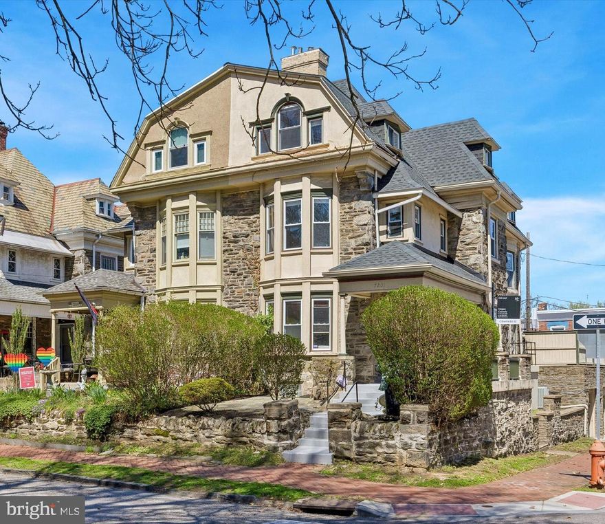 Welcome to this stately stone twin, offering 6 bedrooms, 2.5 baths, and three spacious stories, set on a picturesque, tree-lined street in desirable upper  Mount Airy. A gracious entry foyer with a turned wooden staircase, soaring ceilings, and rich original details creates a warm and inviting first impression.
The formal living room is both cozy and elegant, featuring a beautiful fireplace and abundant natural light, while the adjoining dining room provides the perfect setting for entertaining and everyday gatherings. The updated eat-in kitchen boasts ample cabinetry, an island with seating, a pantry closet, and direct access to a large rear deck—ideal for indoor-outdoor living.
Upstairs, the second floor includes three bright bedrooms and a stylishly renovated hall bath. The primary bedroom offers enhanced closet space and built-in shelving—an uncommon luxury in homes of this era. The third floor adds three more generously sized bedrooms along with another updated hall bathroom complete with a soaking tub.
A full basement with high ceilings offers excellent storage or workshop potential and leads to a huge two-car garage. Additional upgrades include two-zone central air, a newer roof, a waterproofed basement, expanded closet spaces, and fresh paint throughout.
Enjoy privacy and relaxation on the expansive rear deck, the front porch or the front patio area. Conveniently located on a quiet one-way street, this home is just a short walk to the Chestnut Hill East rail line and close to the shops and dining of Chestnut Hill and Mount Airy, as well as Wissahickon Valley Park, with easy access to Center City.