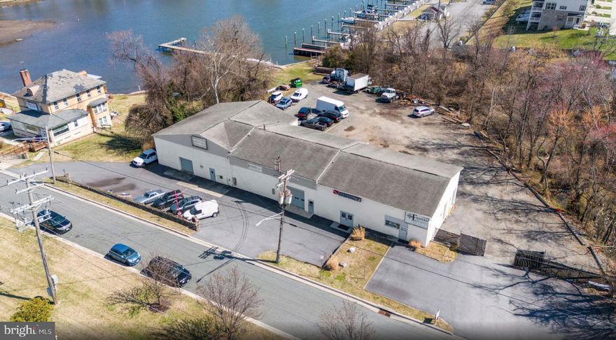 Zoned Commercial Industrial| ±6,936 Sq. Ft. | 2.024 Acres | 148’ Waterfront Available for purchase!  Discover a rare waterfront commercial opportunity at tip of the vibrant shore of Middle River. This prime 2.024-acre parcel features 148 feet of direct waterfront and is zoned Commercial Industrial, offering exceptional flexibility for marine-based operations, investment, or redevelopment. The 6,936 sq. ft. facility includes seven (7) oversized bay doors, a recently replaced roof, and a newly paved blacktop lot providing ample parking and easy maneuverability for equipment and vehicles. With mean water depths of 5 feet (3 feet at low tide), the site is well-suited for boat service, storage, or waterfront access businesses.
The property offers a turnkey investment with steady cash flow and future expansion potential, underscoring its desirability within the marine and industrial community.  Whether you’re seeking to expand your marine enterprise, establish a waterfront commercial hub, or secure a valuable income-producing asset, 1923 Old Eastern Avenue stands as one of the most versatile and strategically positioned waterfront holdings in Baltimore County.