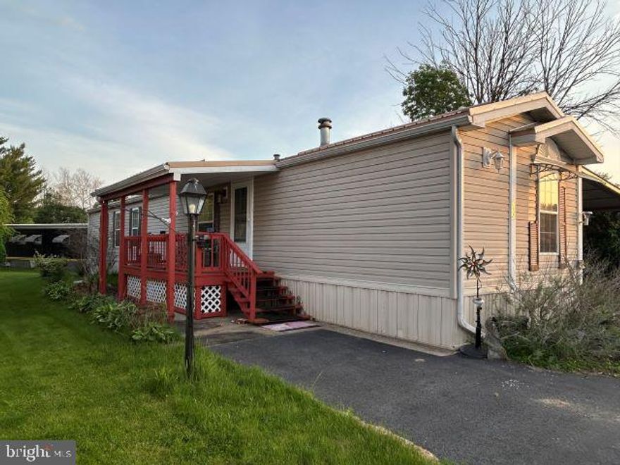 Welcome to easy living in this well-maintained 14x70 mobile home, built in 2000 and located in a desirable 55+ mobile home community. Offering 2 bedrooms and 2 full bathrooms, this home features a spacious, open-concept layout with a functional kitchen complete with abundant cabinetry, ample counter space, and a center island for added prep and storage. The adjoining living area offers a comfortable space to relax or entertain. The primary bedroom includes a private full bath, while a second bedroom and full bath provide flexibility for guests or hobbies. Enjoy outdoor living from the covered front porch and appreciate the convenience of the attached carport for protected parking. A great opportunity for affordable, low-maintenance living in a peaceful community setting.