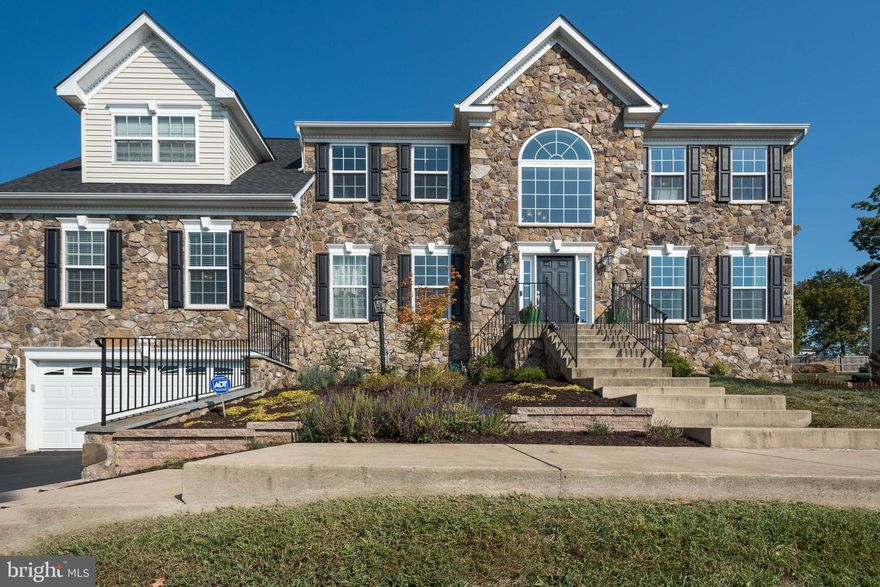 --See 3D virtual tour-walkthrough--A perfect place to call home.  Stunning Stone Front Colonial with over 4800 Finished Sq. Ft.  Main level and upper level Master Bedrooms.  5 beds, 5.5 bath.  No detail overlooked:  Gourmet Kitchen with Granite Counters and Tile flooring.  Kitchen Island with seating.  Large eat in breakfast area.  Formal Dining Room with bay window, chair railing and crown moldings.  Spacious Living room.  Main level office.  Main level half bath.  Expansive Family room with gas fireplace- perfect for family movie nights.  Main level 2nd Master Bedroom/In-Law Suite with full bath.  Upper level laundry.  Large upper bedrooms all with ceiling fans.  Jack and Jill bath and hall bath.  Expansive Master Bedroom with sitting room, walk in closets, 2 extra closets.  Luxury Master Bath with soaking tub, separate shower and dual sinks.  Extra large recreation room.  Two large storage rooms in basement ready to finish or to continue to use as storage.  Lower level Full Bathroom.  2 Car Garage with room for extra parking in the driveway.  Entertain on large two level deck and patio.  Expansive back yard with storage shed.  A commuters dream: minutes from access to I66.  Virginia VRE located a few miles away.  Very close to Virginia Gateway for a convenient and active lifestyle.  Movie Theater, Splash Fountain, restaurants, day care, every kind of service and shopping that you can imagine are close by.