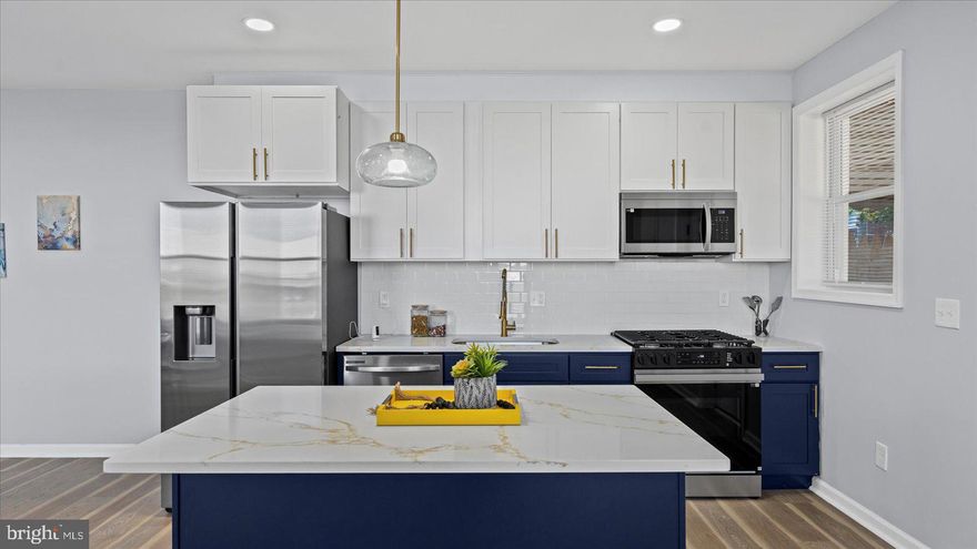 Newly remodeled 5BR/2BA end of row Townhome located on a tree-lined street in Biddle Street.  Step up to the covered front porch and open the door to the first of three newly transformed floors of living space.  The main floor features luxury flooring, recessed lighting, and an open concept floor plan boasting a large living room with a custom feature wall, an open dining area, and stunning kitchen.  The kitchen features mixed-metal accents throughout which includes gold hardware, stainless appliances, and sleek quartz countertops. There are plenty of two-tone cabinets and an island with a pendant light and seating for three or more.  On the second floor are two sizable secondary bedrooms, an open space ideal as a home office, a larger primary bedroom, and a brand new beautifully tiled full bath. The lower level is finished featuring the third and fourth bedrooms, a new full bath with a walk-in shower, a spacious area for family gatherings, laundry, storage, and a walk-out to a Bilco door in the newly fenced yard.  From the kitchen step outside to a covered patio that overlooks some green space and offers so many possibilities.  This home is move-in ready, ideal for any new homeowner, and is located in close proximity to shopping, restaurants, and commuter routes.