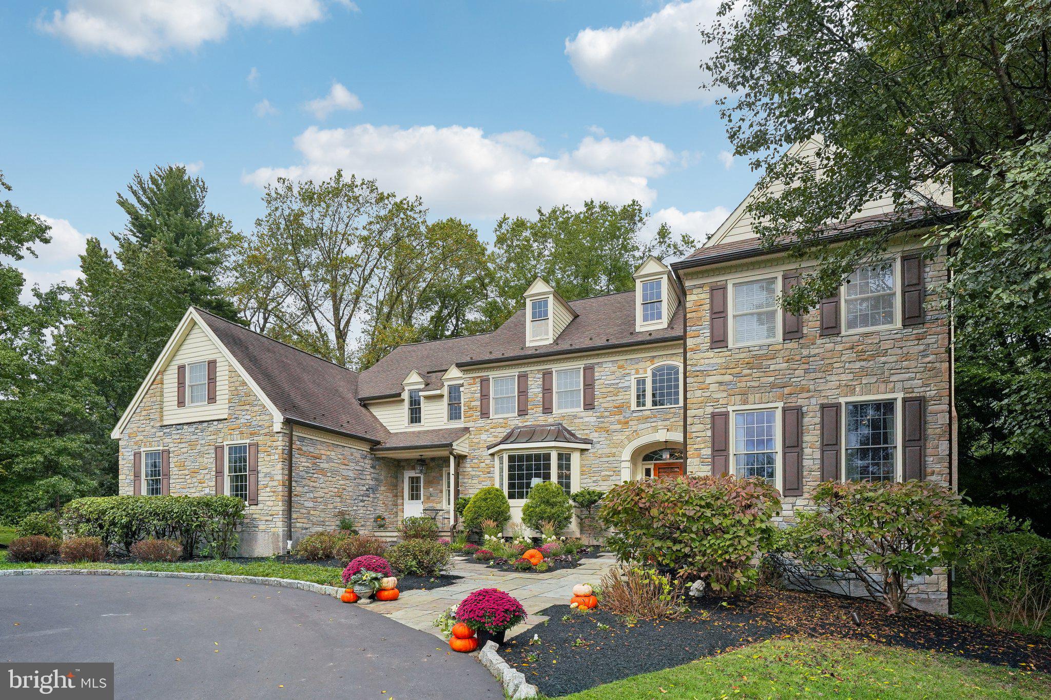 Nestled in the heart of Bryn Mawr’s prestigious Mainline community, this stunning estate, designed by renowned architect Rene Hoffman, exudes elegance and sophistication. This 5-bedroom, 5-bathroom, and 2-powder room residence sits majestically on 2.0 acres of meticulously landscaped grounds, offering both privacy and grandeur.
As you approach the property, you’ll be captivated by the circular driveway, the extensive flagstone hardscaping, and the exquisite stone façade. Upon entering, a grand hallway, extending to the rear of the home and framed by French doors, warmly welcomes you. To your right, the formal living room boasts a gas-burning fireplace, perfect for cozy evenings. To your left, the formal dining room enchants with its classic wainscoting, a spectacular chandelier, and a large bay window. Adjacent to the dining room is a well-appointed bar area, featuring ample cabinetry, granite countertops, and a copper sink and faucet—ideal for entertaining.
Elegant glass doors lead from the living room to a side hallway, which includes a coat closet, powder room, and access to a serene office space overlooking the rear grounds. This office, complete with built-in shelving, offers a peaceful retreat for work or study.
The gourmet kitchen is a chef’s dream, equipped with top-of-the-line Viking appliances, including a 6-burner range, a Sub-Zero refrigerator, and expansive granite countertops. A bright and airy breakfast area provides stunning views of the backyard and access to the flagstone patio, which wraps around the rear of the house and features a charming sitting wall. The adjoining family room, with its stone wood-burning fireplace, also offers picturesque views of the lush rear yard.
Convenience meets style with back stairs leading to the second floor, providing direct access to the oversized 3-car garage, a powder room, and a spacious closet/pantry. This area also has a separate exterior entrance for added flexibility.
The main staircase, thoughtfully designed to overlook the backyard, features a cozy built-in seating area. The luxurious primary suite is a true sanctuary, offering a private sitting area with built-ins, sweeping views of the front yard, a vast bedroom space, his-and-hers walk-in closets, and an expansive bathroom complete with a Jacuzzi tub, large shower, and dual vanities. A second bedroom, located at the front of the home, features its own bathroom and walk-in closet, while two additional bedrooms share a well-appointed Jack-and-Jill bath.
Conveniently located at the top of the back stairs is a laundry room and a spacious bedroom with an en-suite bathroom and ample storage, perfect for an au pair suite or guest quarters.
The finished 1,617 square foot basement is an entertainer’s delight, offering an exercise room, a versatile bonus room ideal for an office or craft space, a work area, a movie theater, a powder room, and abundant storage, plus all major mechanicals.
Don’t miss this extraordinary opportunity to own a piece of Mainline luxury. Schedule your appointment today!