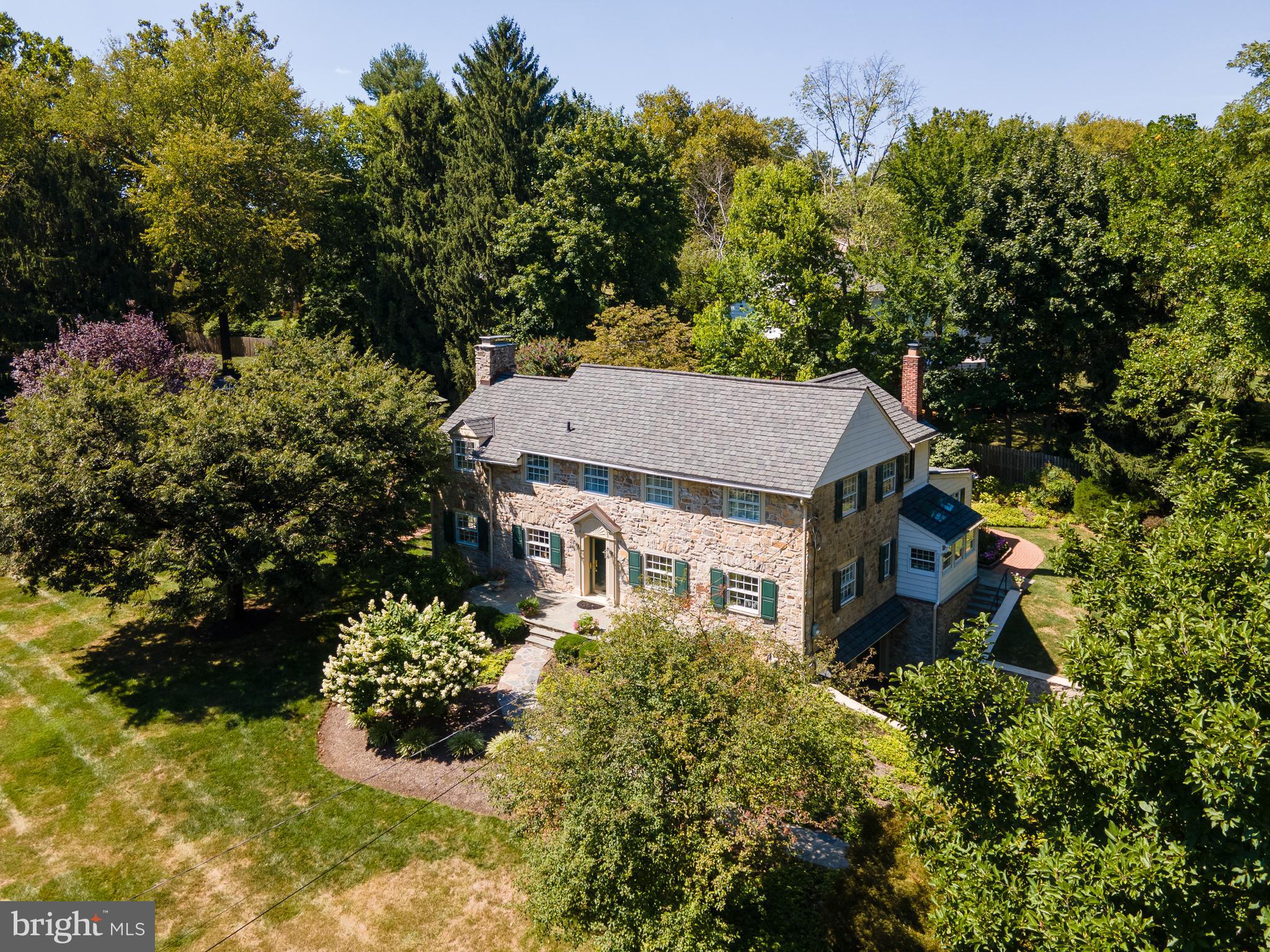 Welcome to 669 Richards Road, a spectacular stone Colonial set on a gorgeously planted lot in the highly sought after Main Line neighborhood of Glenhardie. This is a very rare opportunity to acquire a meticulously maintained home in a prime location within the top ranked Tredyffrin-Easttown School District. An exquisitely finished home offering the perfect blend of Old World charm and modern updating. The gracious center entrance hall opens on the left to the formal living room featuring a gas fireplace with Colonial mantle and marble surround. The spacious formal dining room on the right offers chair railing and is the ideal setting for family gatherings and holiday celebrations. The heart of the home is the gourmet kitchen which features tile flooring, high end Viking, Sub-Zero and JennAir appliances, granite and tile countertops, a tile backsplash, a deep stainless steel sink and pass throughs to both the family room and dining area. The open dining area offers gorgeous exposed stone walls, three skylights, a wood finished vaulted ceiling, a cozy breakfast bar, a custom window seat and a doorway to the rear yard. The fabulous family room is finished with exposed wood beams and features a high end, fully programmable gas fireplace set within a stone wall with an antique Philadelphia brick hearth. A sun drenched alcove with French doors opens from the family room to the fabulous yard and pool area. The butler's pantry with tiled counter and display cabinets connects the dining room to the kitchen. The bright and cheery laundry room is complemented by cabinets from the original butler’s pantry. A nice powder room and a rear staircase complete the picture for the first floor of this stunning home. The second floor is home to the sumptuous owner’s suite which features a surprisingly large walk-in closet outfitted by California Closets. The renovated owner's bathroom is finished with marble flooring and a marble shower plus an extra deep linen closet. Jack and Jill bedrooms are connected via a nicely updated tiled bathroom. A fourth bedroom and a third full bathroom with Corian counters and a Corian shower round off the second floor of the home. The finished basement is a great gathering space featuring a wood burning fireplace, a built-in bar and built-in shelving. A large unfinished room provides tremendous storage. The grounds of this classic home are simply breathtaking. Mature shade trees and gorgeous gardens create an outdoor oasis. A winding brick path leads to the fabulous pool and patio areas, the perfect setting for a "staycation". Relax, entertain, grill, and dine al fresco. Deep window sills, hardwood floors, gorgeous moldings, arched doorways, three fireplaces, extra storage via a walk-up attic, a two car garage, a storage shed and much more all come together to make 669 Richards Road a very special place to call home. A short walk to Valley Forge National Park and close to Trader Joes, Wegmans, the King of Prussia Town Center and the shops, restaurants, and trains of the Main Line. Truly a once in a lifetime opportunity. Welcome home.