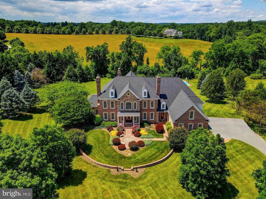 Nestled within the glorious community of Nicholson's Manor in northern Baltimore county, this custom-built brick and stone colonial estate epitomizes luxury living.  Spanning over 10,000 square feet of meticulously designed living spaces, this estate boasts quality construction, refined finishes and unparalleled amenities. Situated on over 6 acres of pristine acreage, the property offers privacy and seclusion while providing ample space for outdoor recreation and relaxation. Step into sophistication through the 2-story foyer with double staircases setting the tone for what awaits within. From the formal living room and dining room, each featuring gas fireplaces and architectural details, to the open sunken family room and expansive gourmet eat-in kitchen, every space is designed with all in mind. Find inspiration in the private office with its own outside terrace, seamlessly connected to an interior sunroom, providing the perfect environment. The luxurious primary suite, complete with all the bells and whistles, is the opulent retreat. The newly completed lower level recreation space offers endless possibilities, with ample spaces for various activities and entertainment.  Additional features include numerous fireplaces, spacious bedrooms and baths, second-floor family room, mudroom, 3 car garage, and more.  Recent upgrades and enhancements are the new bathrooms, pantry, closet systems, wood floors, patio, appliances, and roof.  Enjoy outdoor gatherings and breathtaking views from the recently installed expansive wraparound deck, perfect for hosting guests or simply soaking in the picturesque countryside scenery.  A wonderful opportunity to own this incredible offering! Conveniently located with close proximity to I83, Hunt Valley Town Centre, Oregon Ridge Park and other desirable accommodations.
