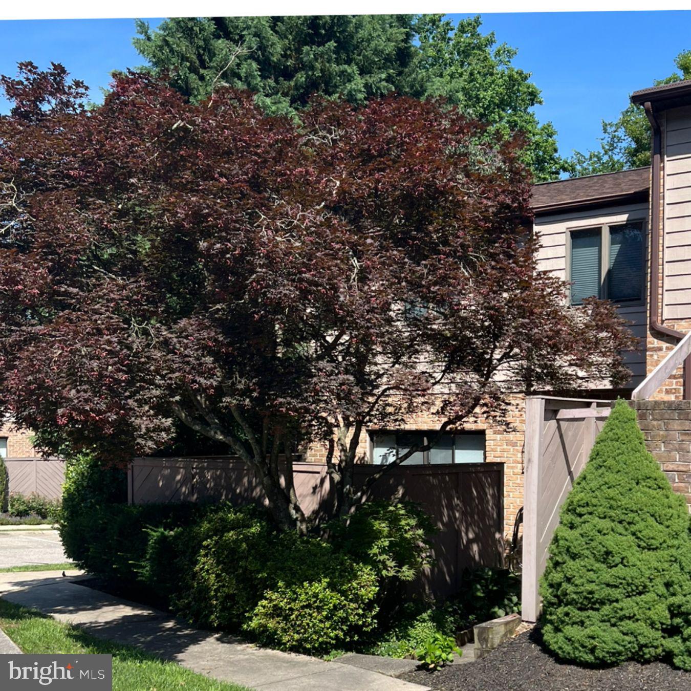 Professional photos coming! This spacious 3-level-end-unit townhome is a modern, light filled residence designed to offer versatility and comfort. The kitchen is updated and cheery and has a small breakfast nook looking to the private front patio, the laundry is accessible from the kitchen as well. A formal dining room opens to the center hall and half bath. The living room boasts a wood burning fireplace, built-ins and den bump out, this space opens to a balcony with a treed view. The upper level has an updated primary bath with double vanities, a walk-in shower and walk- in closet. The large primary bedroom has fresh paint and an abundance of natural light. There are also two additional bedrooms and a hall bath. The lower level is unique, offering a small kitchenette, family room with wood burning fireplace and full bath. This area exits to the rear porch and private driveway but can also be accessed from within the home. You will also find great storage space on this level. Welcome home to 16 Hampshire Woods!