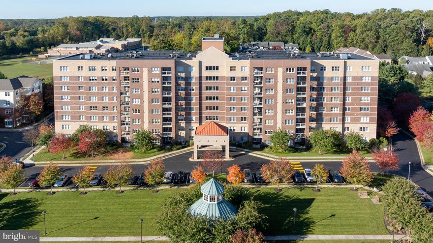 Welcome home to this beautiful 8th Floor Condominium in Building III of the Roundwood Ridge Community.  This 1700 Square foot unit has 2 Bedrooms and a Den.  The den could be used as a third bedroom.  As you enter  into the unit with 8.5' ceilings, the foyer has a coat closet and new wood floors throughout the living area.  The open concept room incorporates the family room, kitchen and breakfast room into a large living space perfect for entertaining.  The kitchen boasts ceiling height cabinets in wood, granite counters, and stainless appliances.  An Island offers more counter space and a great place to watch the football game.  Just beyond the kitchen is a breakfast room/keeping room with plenty of room for a kitchen table.  A gas fireplace add a cozy touch to this area.  Just off the breakfast room is a large balcony with a screen door offering eastern views of the Lutherville Timonium area and the courtyard and gazebo.  Next to the kitchen is a large dining room that can also be used as a den.  The primary Suite has an en suite bathroom with walk in shower and raised vanities for easy access to the sinks.  The second bedroom has its own bathroom across the hall that features a custom shower curtain and a raised vanity.  The den/third bedroom is a nice place for an office or sitting room.  There is also a large laundry room with plenty of storage space.  Down the hallway is more storage in the storage locker area which is included with the condo.  The building's common areas were recently renovated and redecorated.  On the 3th Floor is a community Room where parties are held, and unit owners can meet or reserve for family gatherings.  One parking space is included with the unit, Space Number 48. The building is secure with keycode entry and has two elevators.