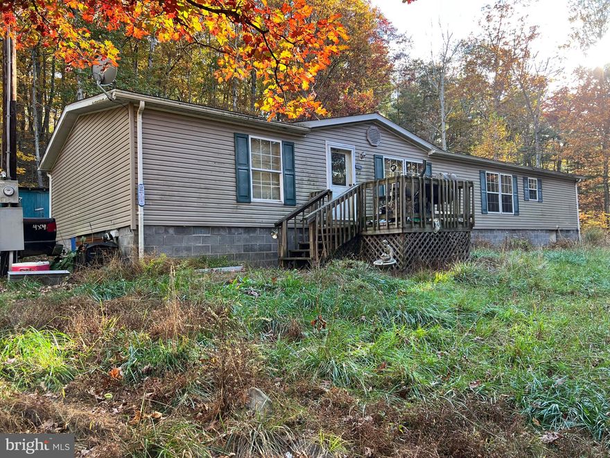Diamond in the rough....over 1800 square feet of living space on six wooded acres and interest in 3.38 acres on river! A little sweat equity can go a long way! Lender will want at least 20% down, but you'll have a nice home in the woods less than 7 miles from Moorefield, with public water, electric, phone and internet available! What a buy! This is AS IS, so it's a matter of cleaning up the interior and exterior to make it your own!