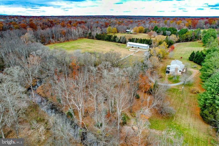 PRICED BELOW RECENT APPRAISAL!! Offered for the first time in nearly 20 years, this 24.61-acre equestrian and recreational property in the heart of Spotsylvania County offers privacy and convenience in an unbelievable setting. The 3,000+ sqft home features 4 bedrooms, a formal dining room, a formal living room, and one additional room in the basement that could serve as an extra bedroom—each with access to a full bath. The large primary bedroom boasts an en-suite full bath with his and her closets. The walkout basement offers abundant space for a workshop, gym, or recreation area. There are 3 fireplaces in the home with a combination of wood and gas. A whole-house generator with a buried propane tank can help you weather the storm! Equestrian enthusiasts will appreciate the 5-stall horse barn (2 horse ready with 3 stalls requiring finishing touches - graded w/stone & floor padding stored onsite) with conditioned tack and washroom, water and electricity, and approximately 12 acres already fenced with a jumping ring. A separate equipment shed provides additional storage for tractors, lawnmowers, etc. The property also features a 6,000+ sqft Morton building with a concrete floor, metal siding, 400-amp service, a roughed-in studio/office that needs completion, and a concrete bunker— with two horse stalls & additional room. Wilderness Run creek borders the west and north sides of the property, creating a private island—ideal for picnics, campfires, morning coffee, or exploring. Gold has even been found in the creek! Conveniently located just 30 minutes from Fredericksburg and major interstates, this property offers rural seclusion with easy access for commuting and amenities! All buyers must provide proof of funds or a preapproval letter. All showings must be confirmed 48-hr before showing. Listing agent will be present for all showings. BRAND NEW UPSTAIRS HIGH EFFICIENCY HVAC INSTALLED OCTOBER 2025!!!!