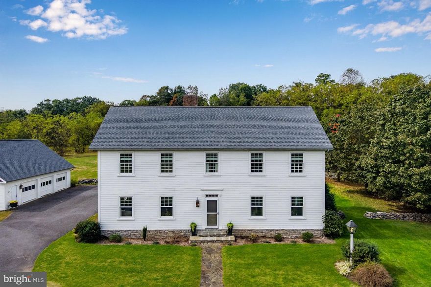 A picturesque long driveway highlighted by beautiful, mature sugar maple trees paves the way to this stunning home, formerly showcased in Country Living magazine. You're guaranteed to appreciate this beautifully designed modern Colonial, nestled upon 5 acres of serene countryside. Custom-built in 2003, this home blends timeless craftsmanship with current, and recent modern finishes throughout. Reclaimed, random-width pine flooring salvaged from a historic Connecticut barn, pairs seamlessly with painted knotty pine trim and woodwork and many period-inspired fixtures. The centerpiece of this home features a fantastic Kitchen and Dining Room, with solid wood cabinetry with inlaid doors, brand new quartz counters, and nearly brand new black stainless steel Refrigerator, Dishwasher, built-in Wall Oven, Cooktop, and deep, stainless steel country sink, all contiguous through a beautiful beamed ceiling. Adjacent keeping room with built-in cabinets and pantry with aesthetic double-sided wood burning fireplace, constructed with stone from the property. Fluid entertaining in the grand Dining Room, with chandelier and northern facing wall of windows. The Formal Living Room is a wonderful space to relax in abundant natural light, with mantle and built-in cabinets. Foyer and Entryway provide passage to the den or office to provide a flex space for homeowners. Spacious First Floor half bath and Mudroom with utility sink and shelving, too. Two options to access the comfortable 2nd floor with brand new Stainmaster carpet in all four Bedrooms, including the private Primary Bedroom with faux brick fireplace, walk-in closet and built-in drawers, complete with en-suite bath highlighted by double vanities, jetted soaking tub, and shower. The additional Bedrooms offer generous spaces, one with a wall of built-in cabinets and desk, and plenty of windows for light, complimented by a guest Bath with shower/tub combo and custom vanity. The convenient second floor laundry room with utility sink and folding table also provides pull down access to attic for additional storage. Enjoy company in the finished Lower Level, complete with a fantastic wet bar adjacent to the Family Room which is wired for sound, and Bonus area which provides a wonderful option for in-home fitness. The 5th Bedroom offers privacy for guests or the perfect space for the craftsperson with adjacent bath. A show-stopping screened in porch with brick floor, beadboard ceiling, and double fans provides a relaxing space and leads to the beautiful 20x40 foot in-ground concrete and slate pool with white picket fence - brand new pool pump and filter installed in June of 2025. The detached 3-bay Garage with 2nd story for additional storage has elevated space for larger vehicles or project cars. This property is complete with a new Atlas Signature Select roof on the house and garage, new Rheem Performance Plus Hot Water Heater, geothermal heatpump, water conditioning, sun tunnel skylights, and much much more. All this in Cumberland Valley Schools, Silver Spring Township, and a fantastic location to call home for future homeowners. Don't wait to appreciate all the blends of timeless history and modern elements that this one-of-a kind home has to offer.