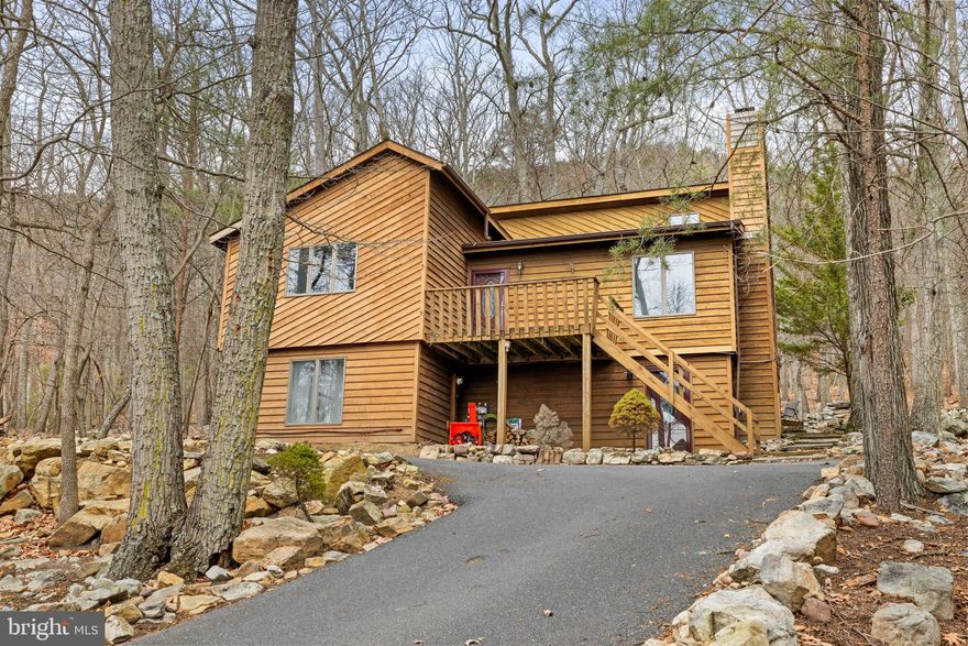 Short-term rental or primary residence, this 4-bedroom, 3 full-bath home is located in the heart of Massanutten, close to skiing, tubing, golfing, fishing, and hiking, making it the perfect place to call home. Cedar siding and contemporary charm create attractive appeal for a four-season resort home. The interior boasts many recent updates and nearly 2,700 square feet of living space. LVP flooring, an updated kitchen with new appliances and cabinets, spacious bedrooms, a living room with vaulted ceilings, and a cozy wood-burning fireplace round out the main level and create a peaceful mountain retreat vibe. The fully finished walkout basement offers an additional family room, two bedrooms, an office, and a recently remodeled full bath. Outside, a firepit and a private deck with two rock fishponds creates the perfect space to relax and watch wildlife. If you’re thinking about owning a mountain retreat in a growing resort, don’t let this one pass you by.