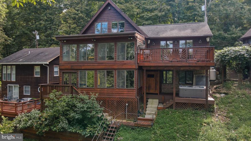 FURNISHED and UTILITIES INCLUDED. You’ll find TURN-KEY living at this exceptional DEEP WATER POTOMAC RIVER lodge. SEASONAL RENTAL available from OCT 1, 2025 until APRIL 15, 2026. Minimum rental term is 90 days. Come enjoy the prettiest season on the river! With 4+ bedrooms and 3 full baths, you can spread out and relax. The main bedroom has sliders to a deck with beautiful views and an ensuite bathroom. Vaulted ceilings bring spaciousness and light to the main level where the living room, kitchen and dining area flow together for easy entertaining. Expansive windows overlook the river, offering sunset views and nature scenes at every turn. The 3-season enclosed sun porch adds a comfortable, sunny sitting area, and the lower level provides additional sleeping space and a second living/dining room for casual gatherings. An upper loft could be used as an office or work-from-home space. Outside, enjoy the seasonal hot water shower.  A deck perched on the river’s edge promises solitude or a base for fishing and kayaking. The monthly rent INCLUDES UTILITIES: water, trash removal, high speed satellite internet, and up to $250 of electricity monthly. Propane fireplace available with the first 100 gallons of propane included. Use the river-facing hot tub for optional $100 per month. FULLY FURNISHED with linens, towels and kitchenware.  The location is 9 MILES FROM SHEPHERDSTOWN and 8 MILES from RT. 81. Please NO DRIVE-BY’s; call for an appointment.