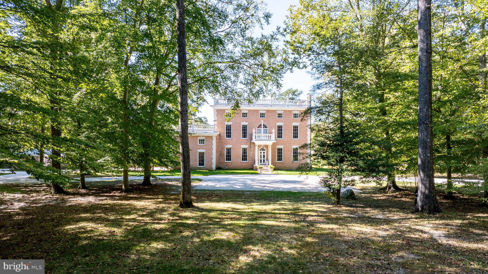 Nestled on a sprawling 42-acre estate adjacent to the historic Wye Heights Plantation, this stately 8-bedroom mansion offers an unparalleled blend of elegance, comfort, and tranquility. The grand interior is marked by soaring ceilings and meticulous detailing, with an elevator providing convenient access across multiple levels. The heart of the home is designed for both relaxation and entertaining, featuring a fully finished basement with a cozy pub and kitchenette. A guest apartment over the garage offers additional private quarters, ideal for hosting family or friends. Outside, a picturesque pond with a charming bridge adds to the serene beauty of the grounds, while the enclosed garden sunroom and an additional sunroom off the breakfast area both offer sweeping views of the gardens and pond. Expansive screened-in porches on both the main and upper levels invite you to savor the peaceful surroundings year-round. Whether you're seeking a private retreat or a magnificent estate for entertaining, this exceptional property provides an exquisite lifestyle amid nature and history.