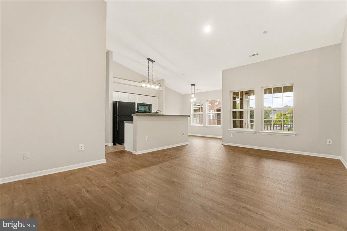 Welcome to this beautifully updated 2-bedroom, 2-bath top-floor condo in the desirable Whittier community. This light-filled home features vaulted ceilings, new hardwood floors, fresh paint, and renovated bathrooms, all contributing to a modern yet inviting atmosphere. With just two flights of stairs in a secure building, privacy and peace of mind are yours to enjoy. Spanning 1,160 square feet, the open-concept layout includes a spacious living area, an elegant dining space, and a bright kitchen designed for both functionality and style. Step out onto your private balcony and take in serene views, perfect for unwinding after a long day.
The generously sized bedrooms offer abundant natural light and ample closet space, creating a comfortable retreat. Additional highlights include in-unit laundry and an assigned parking space for added convenience.
Located just steps from shopping, dining, and everyday essentials, this home is also close to historic Frederick and major commuter routes. The Whittier neighborhood offers a wealth of amenities including three pools, tennis and basketball courts, walking paths, parks, a lake, and multiple tot lots—ideal for an active lifestyle in a welcoming community. Schedule your showing today! **New oven being installed**