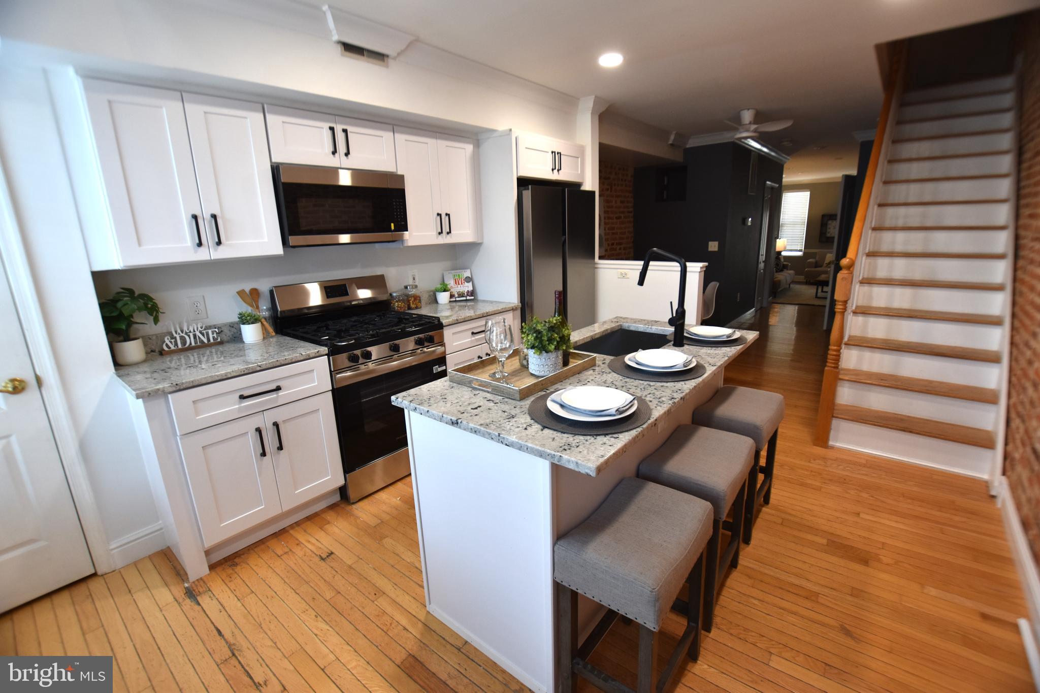 Located in the Heart of Canton find this brick 3 story, roof deck, stone courtyard, 2 bedroom 2.5 bathroom home. The kitchen is new with the full checklist: Island, Stainless appliances, granite, gooseneck bronze faucet, shaker cabinets, and a 5 burner gas stove. The first floor offers hardwoods in the kitchen and dining area, and a heated floor in the living room. The first floor has the ever important half bath which is great while entertaining. The second floor offers the master bedroom with an ensuite including a separate tub and shower, new vanity and new floor. Also, on the second floor is a bonus room perfect for an office, fitness, library etc... The third floor has another bedroom, full bathroom and the entrance to the roof decks. The view from the top roof deck is amazing!