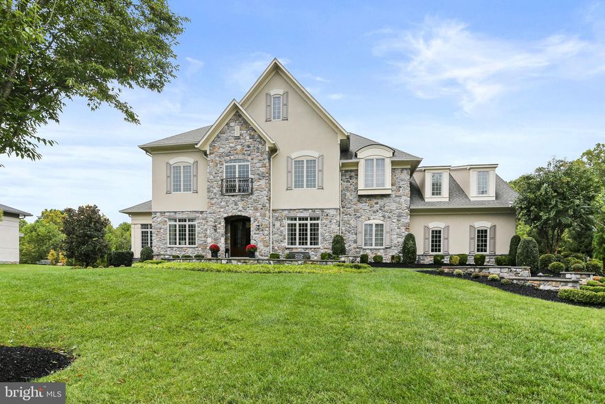 Discover this one-of-a-kind custom-built home by Goodier Builders, boasting 6 bedrooms, 6 full baths, and almost 7,000 square feet of meticulously designed living space. Perfectly situated on a private lot, this home offers exceptional privacy, move-in ready convenience, and is located in a highly sought-after school district.  No detail has been overlooked with professional interior design throughout featuring exquisite custom trim, Board & Batten wainscoting, lighting, and plantation shutters.  Step inside to a grand two-story foyer that sets the tone for the exceptional craftsmanship throughout. The main floor features a formal dining room with built-in speakers and custom window treatments, a living room with a gas fireplace and custom built-ins, and a sunroom with chandelier and plantation shutters. The family room boasts a gas fireplace and coffered ceiling, flowing into the gourmet kitchen outfitted with an oversized island, custom cabinetry, and top-tier Jenn-Air appliances, including extra refrigerator drawers, an ice maker, wall oven, and gas cooktop. An adjacent morning room, full bath, and a versatile bedroom or office round out this level. Additional highlights include hardwood floors throughout, a mudroom with custom built-ins, and two staircases for convenience.   Upstairs, the primary suite is a private retreat, with a tray ceiling, an expansive 10'x18' custom closet, and a spa-like primary bath featuring a jetted tub, frameless shower, Carrara marble, and dual vanities. Additional bedrooms are equally impressive, each with custom closets and en suite baths, including a potential bonus room or playroom.  A second-floor laundry room adds convenience.   The finished basement offers an impressive array of amenities, from a gym and a full bath with a steam shower to a rec room featuring a custom wet bar complete with dishwasher and Sub-Zero wine storage and refrigeration. Relax in the movie room equipped with theater seating, speakers, and lighting, or explore the craft room with custom cabinetry and a bonus room that could serve as an additional bedroom or office.   Outside, you’ll find a fully fenced yard with extensive landscaping and hardscaping, custom lighting, and an in-ground saltwater pool perfect for entertaining. Enjoy evenings by the stone fireplace with pergola or grill up a feast on the built-in outdoor kitchen. The home also includes a 3-car garage, a whole-house generator, and Trex decking, all backing to a conservation forest for ultimate privacy.   This home combines timeless elegance with modern convenience in a sought-after community, offering luxury living at its finest. Don’t miss this opportunity to own a custom-built gem in the prestigious Walnut Grove Community.