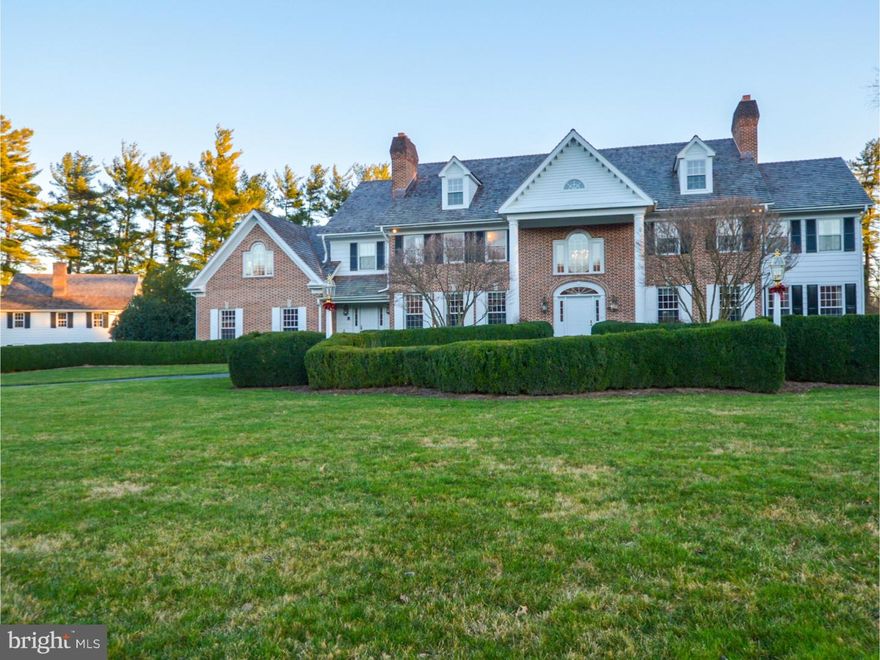 A certain elegance radiates from this custom brick manor home in quiet dignity on 2.7 acre parcel.  Designed in Federal style which endorses the separate original historic guest house amid the tree lined lot. Well placed landscaped beds and circular driveway add to the eye fillings sites all around. Stately and grande on the outside, inside is a more delicate grace. A 2-story entrance hall with dental moldings and a curved staircase enhance the entrance.  10' Ceilings through first floor. There are four fireplaces that emphasize the soft formality of the living room, dining room and family room.  The kitchen includes a center island, granite counter tops, 42" cabinets, 6 burner stove with new back splash and new stainless sinks. Thermador cook top & Thermador side by side  built in refrigerator. Kitchen is open to the newly carpeted family room which radiates a sunny elegance through the glass paned doors leading to the patio. Meander upstairs to the Main bedroom with sitting room, Large bath and huge walk in closet.  3 additional bedrooms ...new carpet  installed in two bedrooms and Jack & Jill bath newly renovated. Walk up attic and additional attic at end of hall which could be an additional room.  Guest House full of history & character and could be a separate in law home. New Cedar Shake Roof on house and Guest home. Shopping close by in Flourtown & Chestnut Hill and close to public transportation!