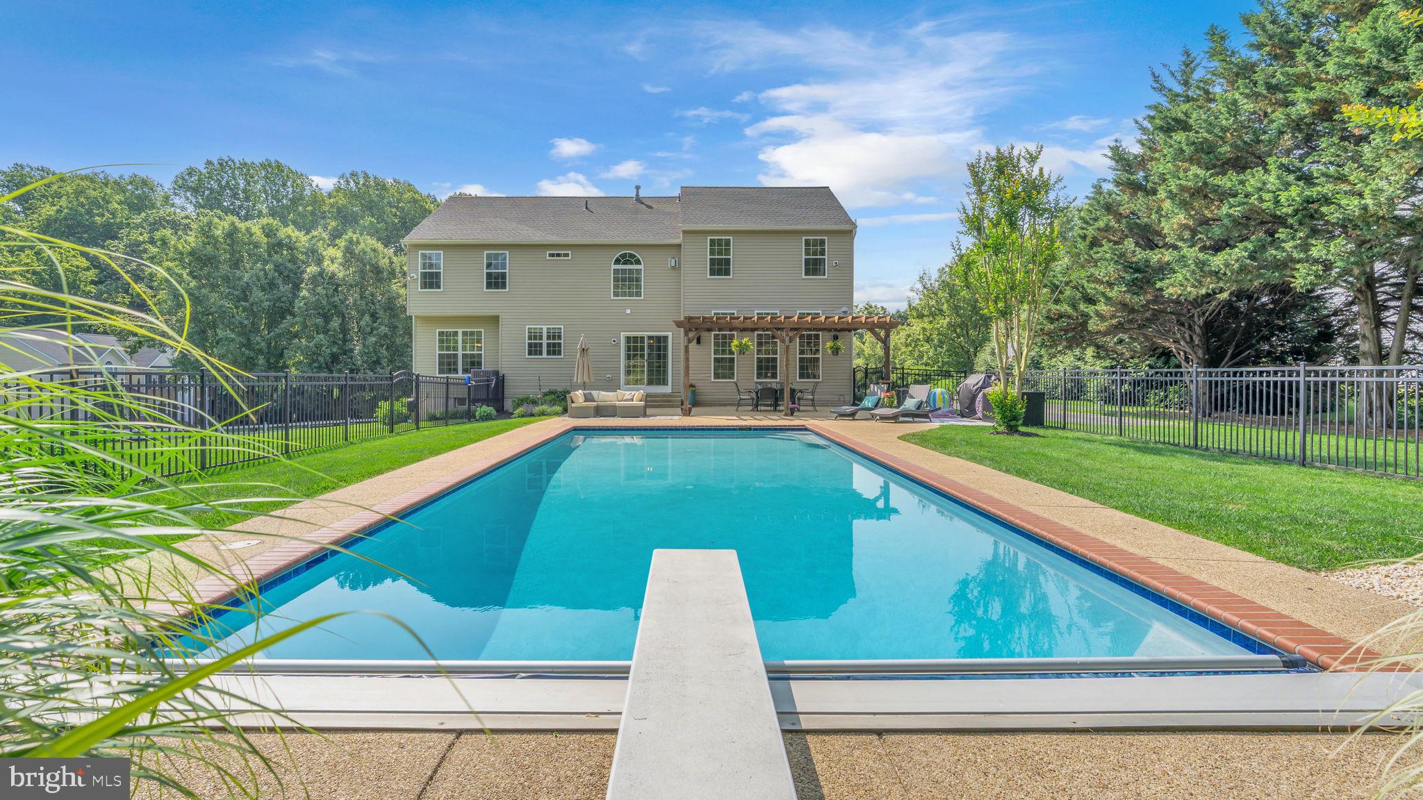 Welcome to this beautifully updated 4-bedroom, 2 full bath, 2 half bath single-family home in Huntingtown, Maryland—offering comfort, character, and convenience both inside and out. Step into your private backyard retreat, featuring a gunite saltwater pool with LED lighting, a diving board, and an automatic safety cover, all surrounded by elegant wrought iron fencing. Just beyond the pool, enjoy an open, unfenced area—perfect for family gatherings, gardening, or play. A chicken coop and shed (both convey) complete the outdoor experience. Inside, the home is loaded with thoughtful updates and flexible living spaces. A dedicated home office provides the perfect work-from-home setup, while a formal dining room and private living room offer plenty of room for everyone. All bathrooms have been tastefully renovated, including the luxurious primary suite featuring a private fireplace, ideal for relaxing at the end of the day. The spa-like en-suite bath includes a navy double vanity with modern fixtures, a soaking tub, and a walk-in tiled shower. The gourmet kitchen is a showstopper, with quartz countertops, 42” white cabinets, and a subway tile backsplash, opening seamlessly into a spacious family room that walks out to the backyard oasis. The finished lower level offers incredible versatility—host friends for a game night, or take advantage of the bonus room as a home gym, hobby space, kids’ play area, or extra storage. Major system upgrades include a new roof (2020) and a new HVAC system with heat pump and furnace (2023), new gunite and automatic safety cover (2024) (giving you energy-efficient comfort for years to come. And the location? Unbeatable—just 28 miles to Joint Base Andrews, 35 miles to the U.S. Capitol, and 40 miles to DCA. With flexible living spaces, luxurious updates, and a backyard built for relaxation and entertaining, this Huntingtown gem truly has it all. Come see it for yourself—your dream home awaits!