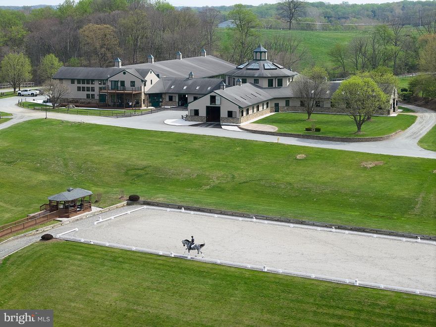 This offering marks an extraordinary opportunity to acquire one of North America’s most prestigious properties. While the 437.5 acre farm is globally celebrated for its history of breeding, training, and raising excellence and many world-class sport horse champions, the focus now turns to the sale of the physical estate, a masterpiece of equestrian infrastructure and natural beauty now available for its next chapter.
The property is defined by its remarkable landscape, featuring 200 wooded acres of mature trees, 220 acres of pastureland, and 15 acres of impervious structures across the gently rolling terrain of Cecil County. Bordered by 1.3 miles of tranquil waters of the Octoraro Creek, the land offers a rare combination of high-performance utility and serene privacy. The sale includes comprehensive, established equestrian infrastructure, highlighted by a 36-stall main barn, 2 outdoor arenas, 12 fields, 31 paddocks, 14 dwellings, 2 additional barns, and numerous equine facilities that have served as the benchmark for elite sport horse development for decades.  
The true value of Hilltop Farm’s footprint lies in its versatility; it is a canvas limited only by the scale of one’s imagination. While its equestrian pedigree is unrivaled, the estate invites a bold repurposing as a world-class Agri-Tourism Destination or a Private Legacy Compound. The riverfront and woodlands are perfectly suited for a Luxury Wellness Retreat, with riparian trails just a stone's throw from the urban corridors of Philadelphia, Baltimore, and DC. 
As this historic operational chapter concludes, the property is now positioned for a new curator to inherit a landscape of immense function and beauty.  This is a rare chance to own a sanctuary that has been both a stage for international sport and a community standard-bearer.