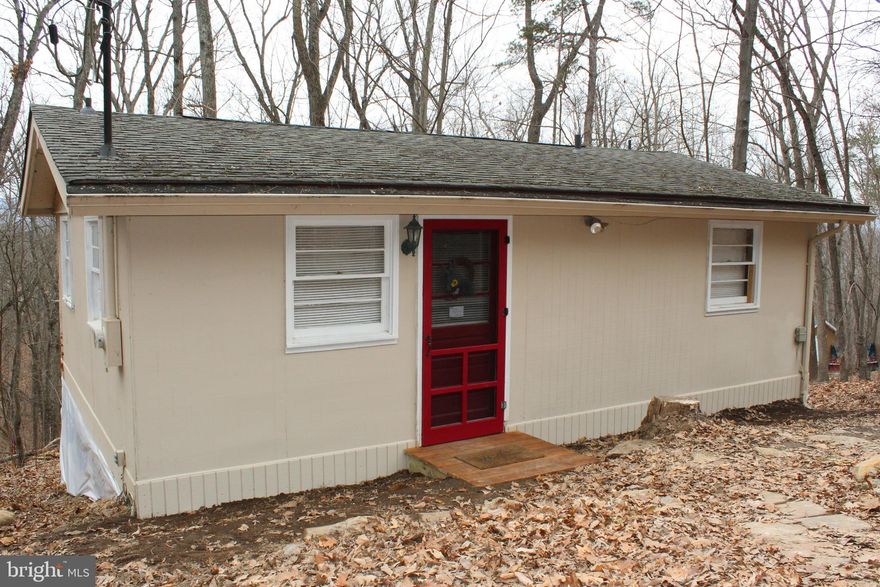 WHAT A CUTE LITTLE CABIN- Come Stay For Your Weekend Get-Aways & Vacations Or Stay The Year Round! Would-Be Great As An Air B&B, For You Investors Too! "What A Large Work Shop"  20X16  Insulated With Electricity, Baseboard Heat & Air Conditioning For All You Crafters, Artists, Wood Workers Or Just Extra Space For Friends To Come Visit! This Cabin Is A Very Spacious 1 Bed, 1 Bath With A Large Updated Kitchen With Custom Cabinets, Newer Counter Tops, Stainless Steel Appliances, And New Viny Flooring. Good Size Bathroom With Custom Cabinets Large Linen Closet And Walk In Shower. The Bed Room Has New Carpet, Large Closet & Vaulted Ceilings. Many Updates Just Completed with in the last few months. So Close To The Shenandoah River You Could Almost Walk There! Just Imagine Swimming, Kayaking & Fishing All Day Then Heading Into The Historic Town Of Strasburg For Dinner & Antique Shopping. Plan For Another Day To Check Out The Old Train Station, Strasburg Musem, And Local Brewery. Need To Travel Or Commute? Rt. 81 Is Just 5 Miles From Home Or If You Want To Check out Front Royal, It's Only 15-20 min. Away For Skyline Drive & Caverns.... I Could Go On And On .... Just Don't Miss Out On This Little Gem !!! Call For An Appointment Today !!!