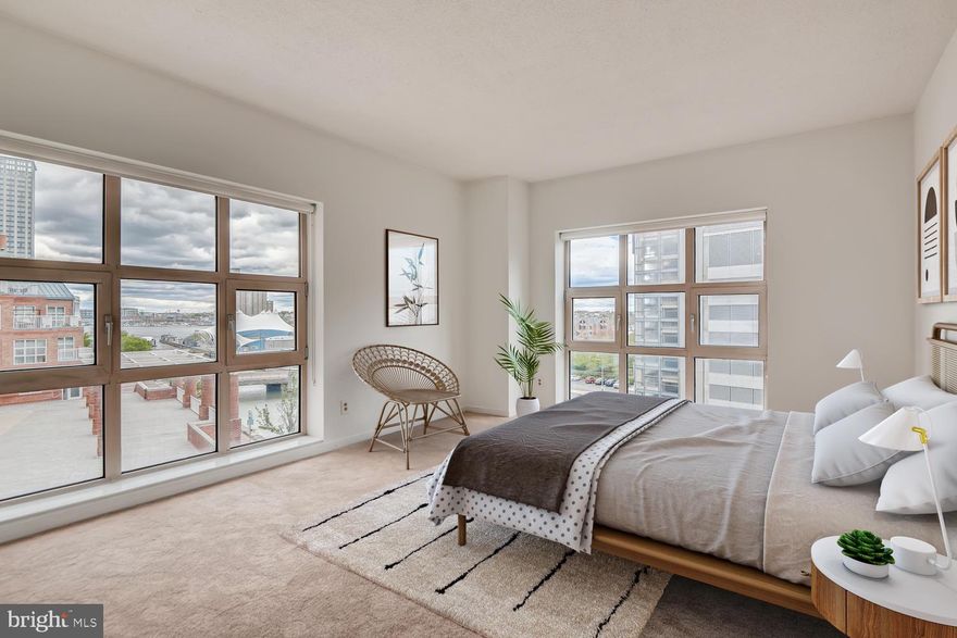 Enormous luxury corner unit offers hardwood floors, granite kitchen and almost 1900 Square feet of living space.  Beautiful water views overlooking Inner Harbor.  Located adjacent to Harbor East on the waterfront promenade - convenient to everything!  Parking included in attached garage plus indoor pool, gym and newly renovated resident library/lounge/sundeck.  All the high-end amenities in an uber premium location.   Come take a tour and see the amenities of this tony condo residence.