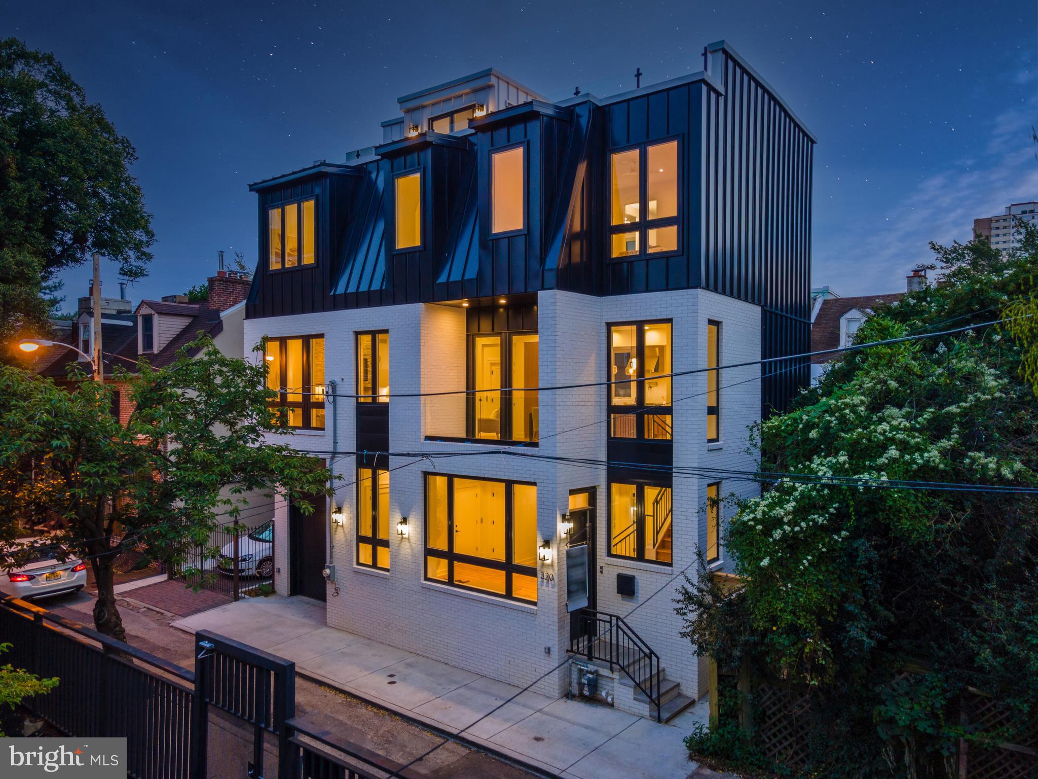 This unique, completely detached home, is unlike any you will find in the city. Sitting on a 42 foot wide lot, this home is 39 feet wide. Absolutely stunning from the inside out, located on a quiet, secluded street in the heart of Queen Village. This home features a 2 car garage, 4 bedrooms, 4.5 bathrooms, Elevator, 3 outdoor spaces, Meredith Catchment, approved 10 year tax abatement, tons of closet space and much more. Upon entering you are welcomed by a large beautiful bright foyer, this first level also has the 2 car garage and large bedroom with full en-suite bath perfect for a guest room, office, workout space or den. Walk up to the sprawling, wide open main level with tall ceilings and flooded with natural light. This floor is complete with the timeless chef's kitchen featuring top of the line Miele and Sub-Zero appliances, as well as high end custom cabinetry and a stunning marble and mother of pearl backsplash. The large dining room leads out to a balcony overlooking the quiet tree lined street. The living room is centered around a beautiful fireplace. This level also has a convenient powder room, huge walk-in pantry adjacent to the kitchen as well as an extremely convenient large laundry room. Up one more level to three bedrooms conveniently all on one floor. Primary bedroom has a walk-in closet and jaw dropping en-bathroom, complete with soaking tub, 2 separate vanities and luxurious glass enclosed shower. Up one more level is a large and very private roof deck with sprawling City views including the Center City Skyline and both Ben Franklin and Walt Whitman Bridges. The elevator is accessible on every level from the finished basement to the roof deck. The finished basement if very large with high ceilings, fantastic natural light and another full bathroom ideal for an extra hangout space, home gym or both. This luxurious home checks all the boxes and is ready for you to move in! Move right in to this 100% completed new construction home with approved 10 year tax abatement.