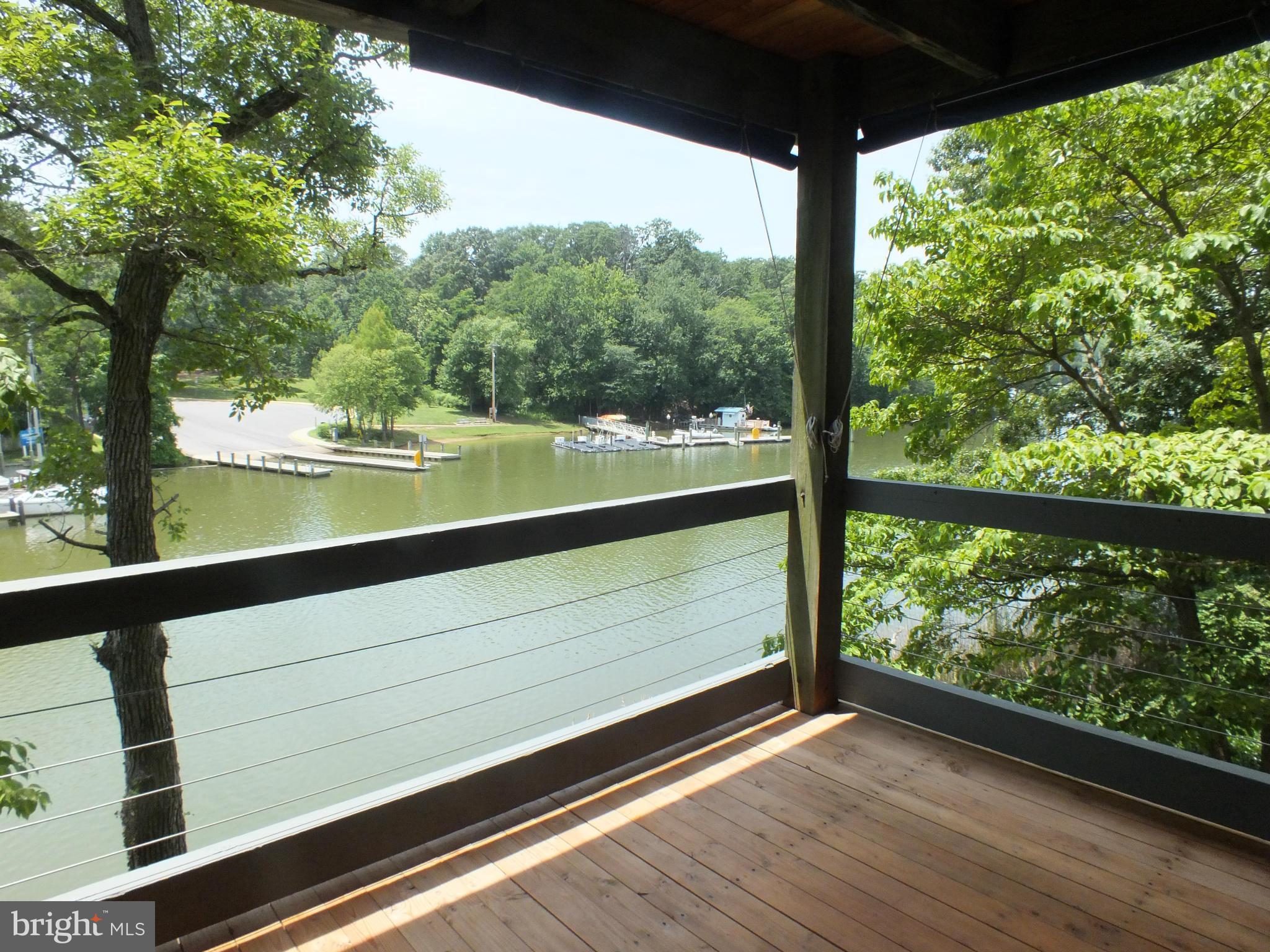 Delightful first floor condo | no steps | Hardwood floors | Romantic wood burning fireplace | Bright sunny windows | Private deck Scenic vistas of wildlife, Blue herons, yachting, kayaking, and paddle boarding on Spa Creek. Amenities include gated entrance, wf pool, racquetball, marina, tennis, & racquetball court. Walk, bike or call the water taxi to downtown Annapolis.