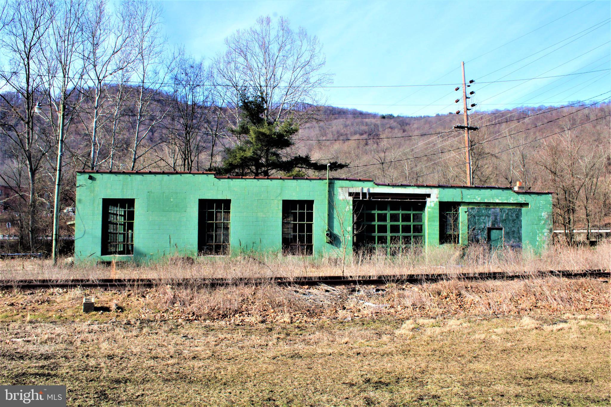LARGE 74X40 BLOCK GARAGE LOCATED ALONG MAIN HWY - FORMERLY USED AS AN AUTOMOTIVE REPAIR BUSINESS - FEATURES TWO 12X10 GARAGE DRS AND ONE 10X8 GARAGE DR - METAL ROOF IS NEWER (AGE UNKNOWN) LOCTATED ON POSSIBLE/PROPOSED GEORGES CREEK TRAIL (NOT YET APPROVED OR GUARENTEED) A COPY OF THE DOCUMENT CAN BE PROVIDED - EASY TO VIEW - BUYER TO VERIFY IF FLOOD INSURANCE WOULD BE REQUIRED - PROPERTY BORDERS GEORGES CREEK - FORMER WESTERN MD RAILROAD HAS RIGHT OF WAY THROUGH PROPERTY - VERY UNIQUE PROPERTY. LOCATED ON CREEKSIDE DRIVE